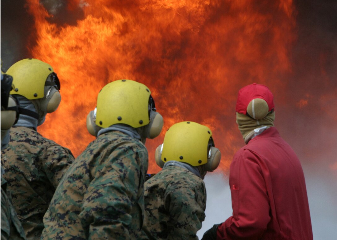 Members of the 26th Marine Expeditionary Unit take the Carrier Fire Fighting Course at Camp Lejeune, N.C. on June 7, 2006. The course was instructed by Navy personel from Nolfolk, V.A.