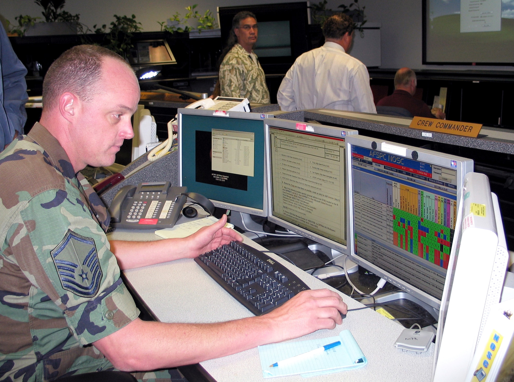 Master Sgt. Pete Norris reviews information on the Air Force Space Command major command coordination center, or MCCC, display at Peterson Air Force Base, Colo., on Thursday, June 1, 2006. The display facilitates tracking of mission system compliance with all security software updates. Sergeant Norris is a crew commander assigned to the new MCCC. (U.S. Air Force photo/Capt. Joe Macri)
