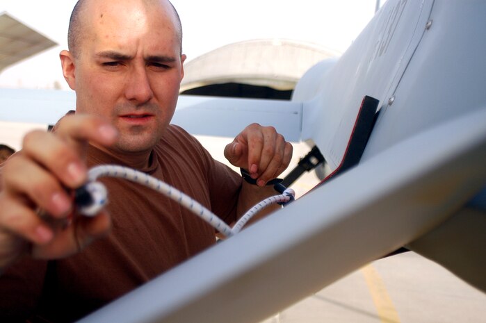 Staff Sgt. Steve Fraser attaches a brace to the tail of an MQ-1 Predator at Kandahar Airfield, Afghanistan, following a sortie in support of Operation Enduring Freedom on Friday, June 2, 2006. Sergeant Fraser is a crew chief deployed to the 62nd Expeditionary Reconnaissance Flight from Nellis Air Force Base, Nev. (U.S. Air Force photo/Maj. David Kurle)