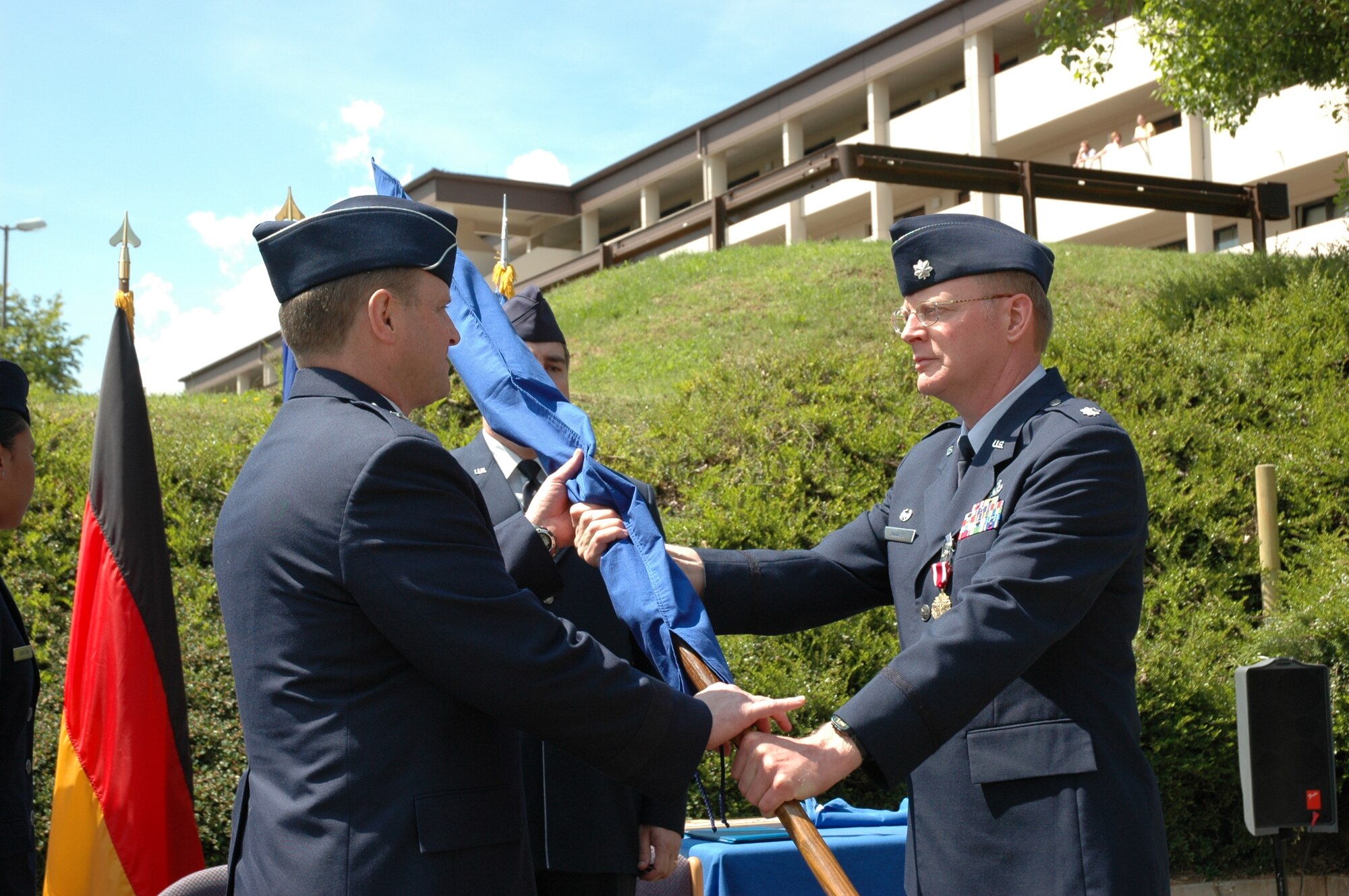Brig. Gen. Jay Lindell, USAFE Director of Logistics, accepts the folded USAFE Regional Supply Squadron flag from Lt. Col. Mark Hawley, USAFE RSS commander at the inactivation ceremony at Sembach AB Wednesday. The USAFE RSS is the first MAJCOM RSS to transition the workload to the new Logistics Support Centers.