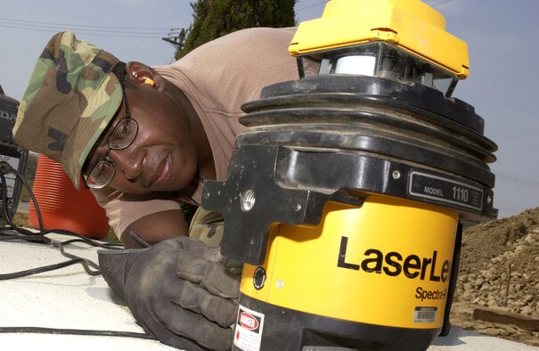 Tech. Sgt. Karnelius Palmer prepares a leveler before laying concrete at Osan Air Base, South Korea, on Tuesday, May 16, 2006. Airmen from Red Horse squadrons at Nellis Air Force Base, Nev.; Barksdale AFB, La.; Andersen AFB, Guam, and Osan are working through September on various quality-of-life improvement projects in South Korea. Sergeant Palmer is with Barksdale's 307th Red Horse Squadron. (U.S. Air Force photo/Tech. Sgt. Demetrius Lester)             