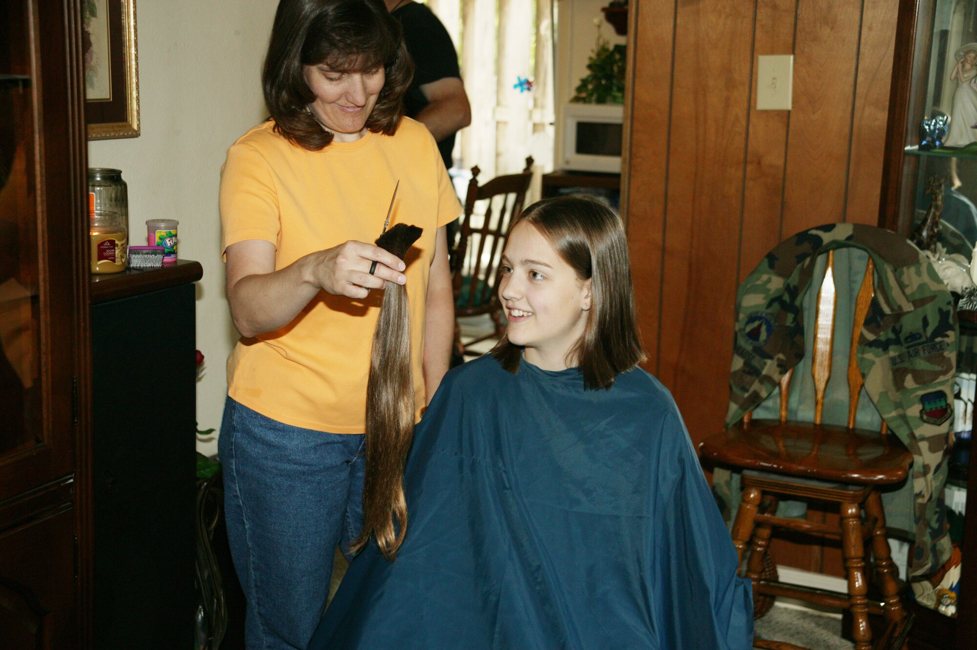 Bethany looks at her 18-inch pony tail moments after it was cut. This was Bethany's first-ever haircut.  (U.S. Air Force Photo/Tech. Sgt. Kevin Williams)
