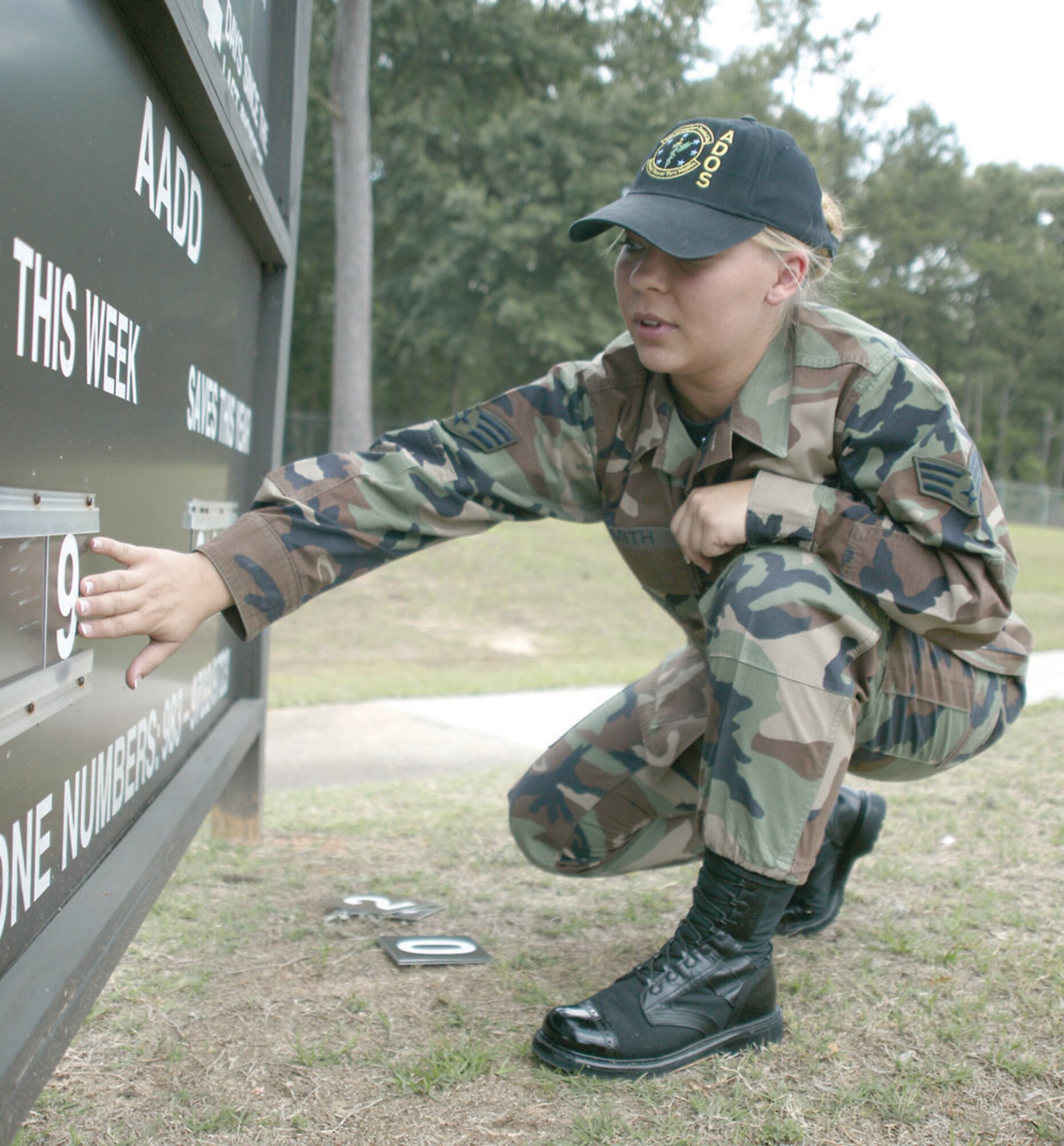 Senior Airman Susanne Smith, Airmen Against Drunk Driving president, updates the AADD board at the main gate. (U.S. Air Force Photo/Senior Airman John Gordinier)