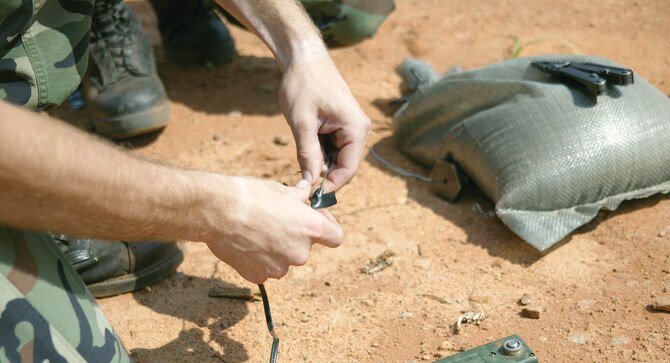 An EOD technician prepares an electrical .50 caliber cartridge to fire a disruption tool. (U.S. Air Force Photo/Senior Airman John Gordinier) 