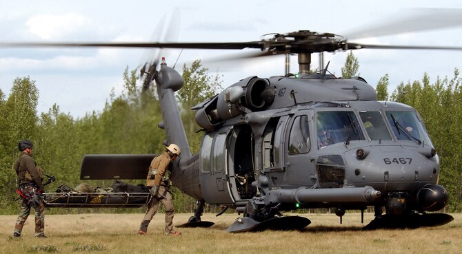 Airmen from the 31st Rescue Squadron at Kadena Air Base, Japan, load a patient onto an HH-60 Pave Hawk during a combat search and rescue mission for exercise Northern Edge 2006 at Fort Wainwright, Alaska, on Tuesday, June 6, 2006. Northern Edge is a joint training exercise hosted by Alaskan Command. It is one of a series of U.S. Pacific Command exercises that prepare joint forces to respond to crises in the Asian Pacific region. (U.S. Air Force photo/Staff Sgt. Joshua Strang)