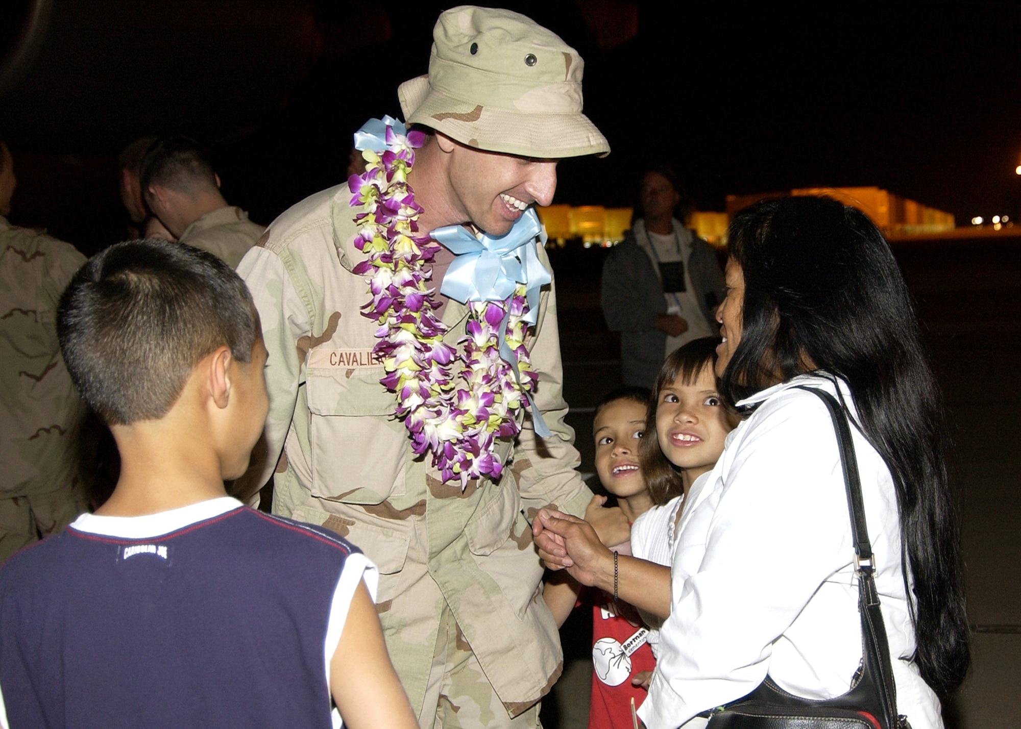 Tech. Sgt. Michael Cavalieri reunites with his wife, Sheri, and children Joseph, Anthony and Mahinalani at Davis-Monthan Air Force Base, Ariz., on Tuesday, June 6, 2006, after a deployment in support of Operation Enduring Freedom. Sergeant Cavalieri is a weapons crew chief with the 563rd Maintenance Squadron. (U.S. Air Force photo/Airman 1st Class Veronica Pierce) 