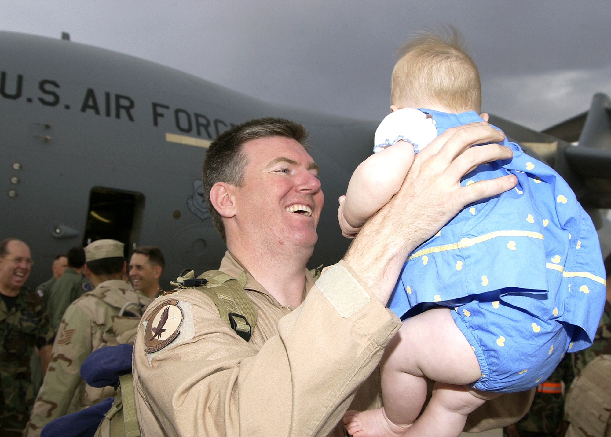 Maj. Steven Ammons reunites with his daughter, Kylie, at Davis-Monthan Air Force Base, Ariz., on Tuesday, June 6, 2006, after a deployment in support of Operation Enduring Freedom. Major Ammons is an HH-60G Pave Hawk pilot with the 55th Rescue Squadron. (U.S. Air Force photo/Airman 1st Class Veronica Pierce)