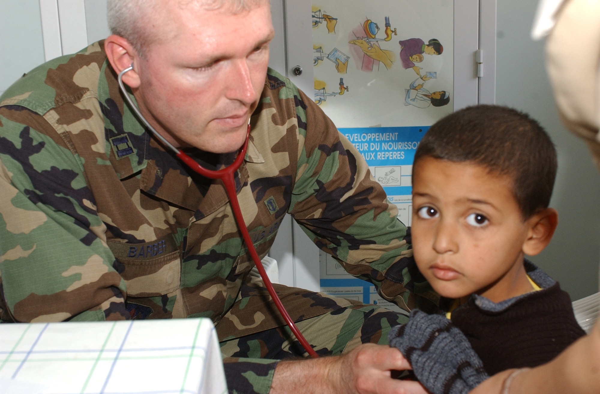 Capt. Alvin Barber, 435th Medical Squadron physician assistant, examines a Moroccan boy in the village of Ifrane, May 25, 2006 during the humanitarian medical mission as a part of Exercise African Lion 2006.