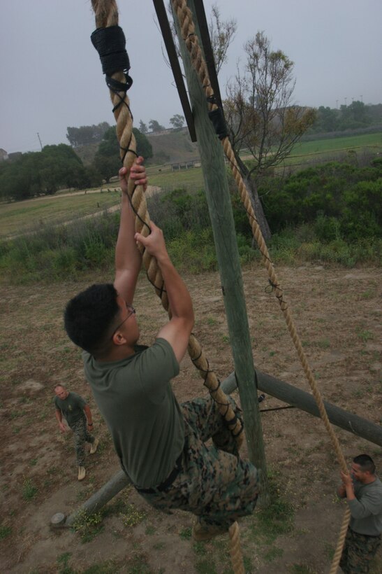 Petty Officer 3rd Class Mark Tantingco climbs to the top of his class on the obstacle course rope, showing to the rest of his classmates that there?s nothing too hard for a petty officer to handle.