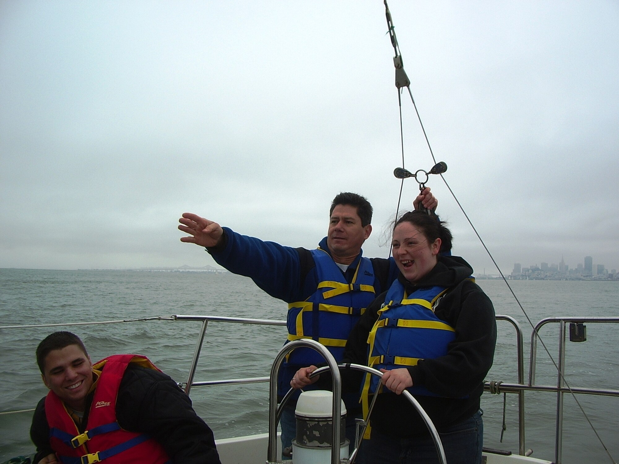 Lt. Col. Rick DeLeon gives Airman 1st Class Kayley Saphner a few pointers on how to sail. The Travis Marina, which is located in the Golden Gate National Recreation Area at the north end of the Golden Gate Bridge, offers sailing lessons and boat rentals. (Courtesy photo)

