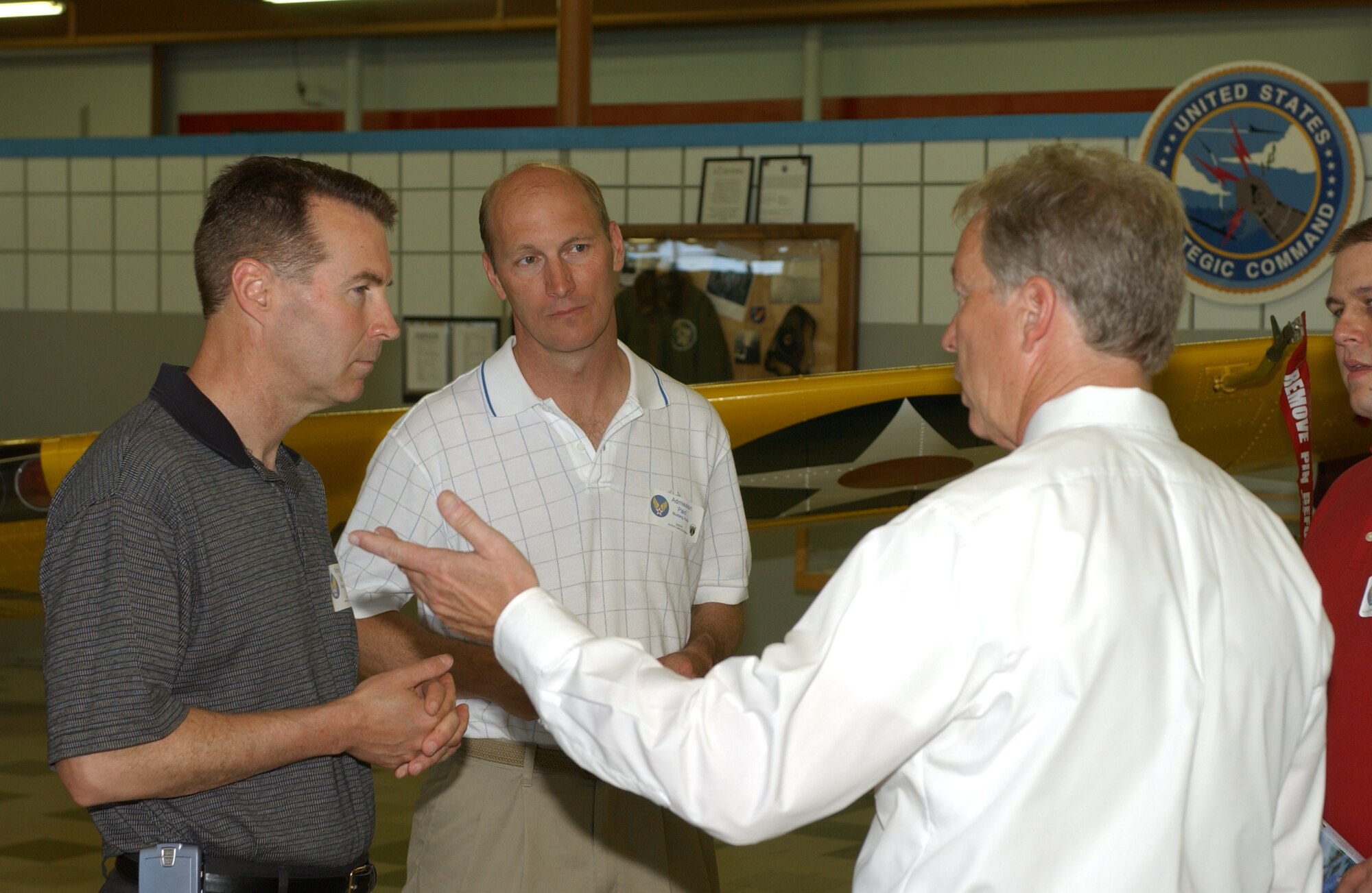 Mr. Mark Pieschke (right), Northern California Friends of the American Fighter Aces director, talks to Col. Steve Arquiette, 60th Air Mobility Wing commander, and Col. Timothy Zadalis, 60th AMW vice commander, during the Aces Symposium Sunday. (U.S. Air Force photo/Andre Mansour)