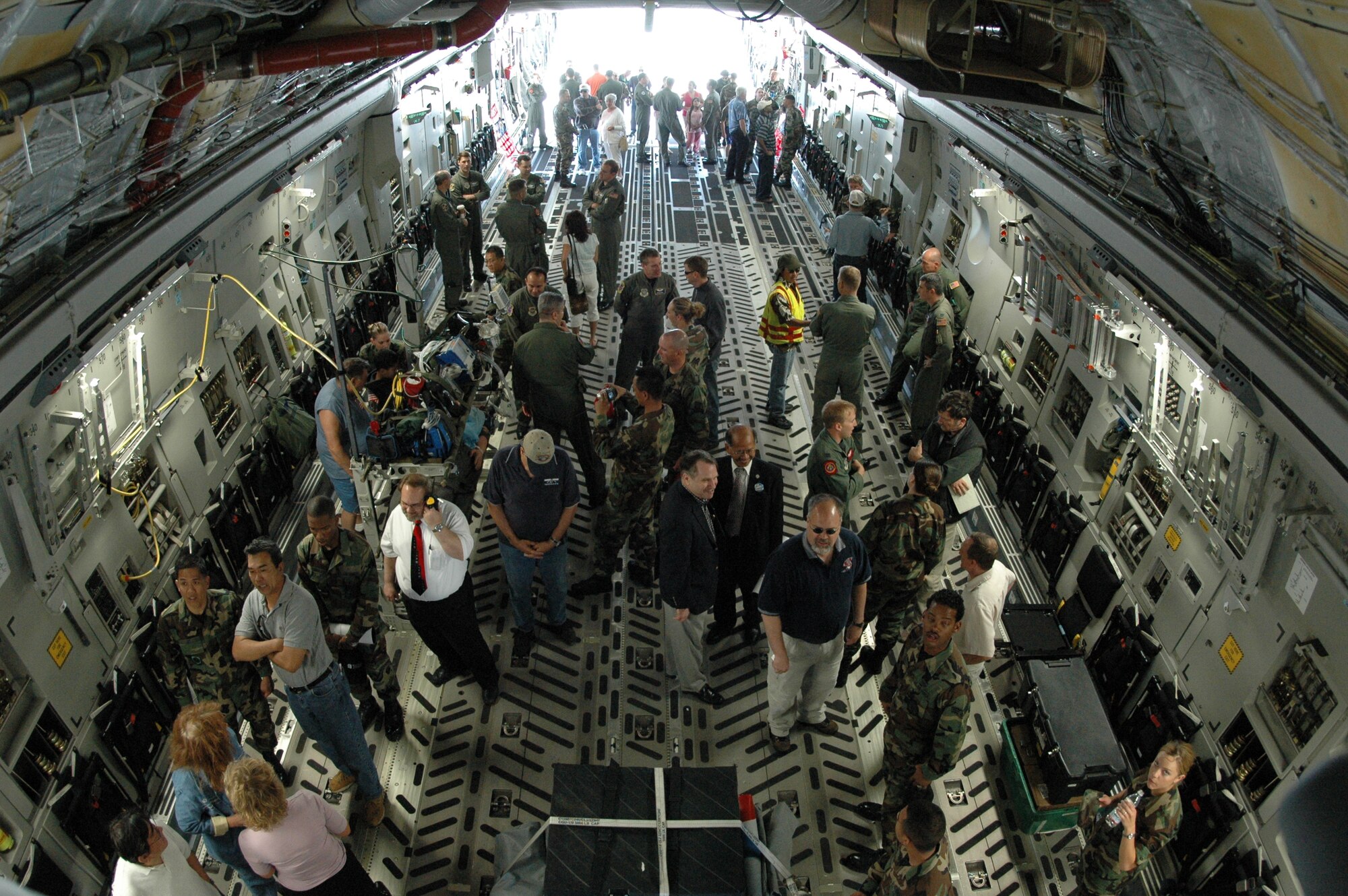Base and local community members check out the inside of a C-17. While the aircraft was on display, aircrew members from the 21st Airlift Squadron, 301st AS and 860th Aircraft Maintenance Squadron at Travis and 729th AS from March Air Reserve Base, Calif., were available to answer questions. (U.S. Air Force photo/Staff Sgt. Raymond Hoy)

