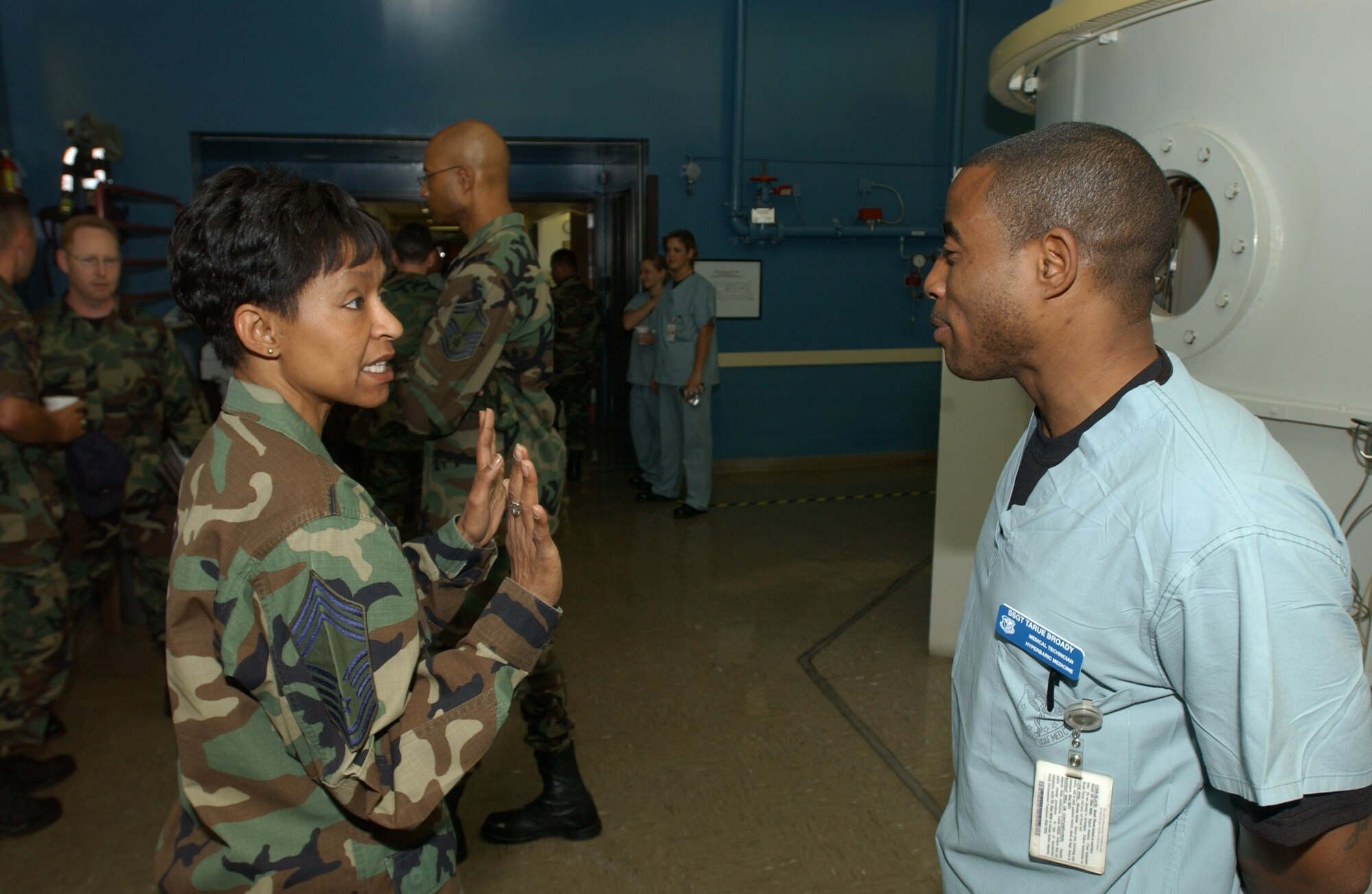 Chief Master Sgt. Carol Johnson, 60th Air Mobility Wing interim command chief, speaks to Staff Sgt. Tarue Broady, 60th Aerospace Medicine Squadron hyperbaric medicine medical technician. (U.S. Air Force photo/Andre Mansour)