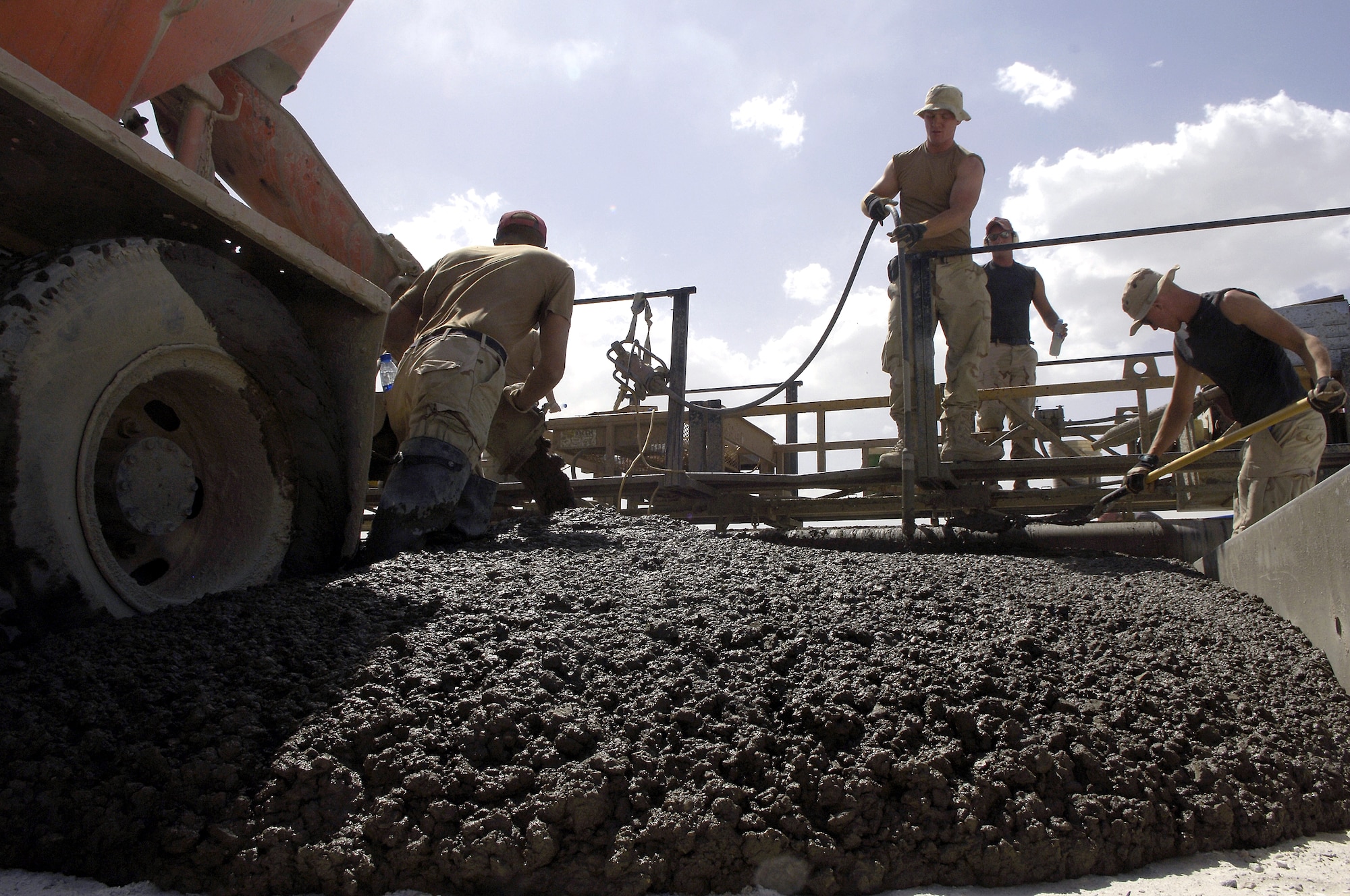 Members of the 1st Expeditionary Red Horse Group, Bagram, Afghanistan, pour concrete for a new ramp here June 5, 2006.  The ramp will provide support for close air support aircraft, such as the A-10 Thunderbolt II. (U.S. Air Force photo/Senior Airman Brian Ferguson)
