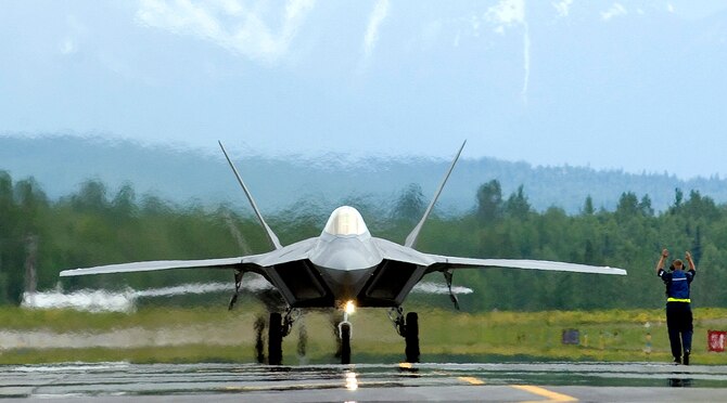 A crew chief with the 1st Fighter Wing from Langley Air Force Base, Va., directs an F-22 Raptor as it taxis down the runway after completion of its mission during Exercise Northern Edge 2006, on Wednesday, June 7, 2006.  The joint training exercise, which runs from June 5 to 16 and is hosted by Alaskan Command, is one of a series of U.S. Pacific Command exercises that prepare joint forces to respond to crises in the Asian Pacific region. (U.S. Air Force photo/Senior Airman Garrett Hothan)