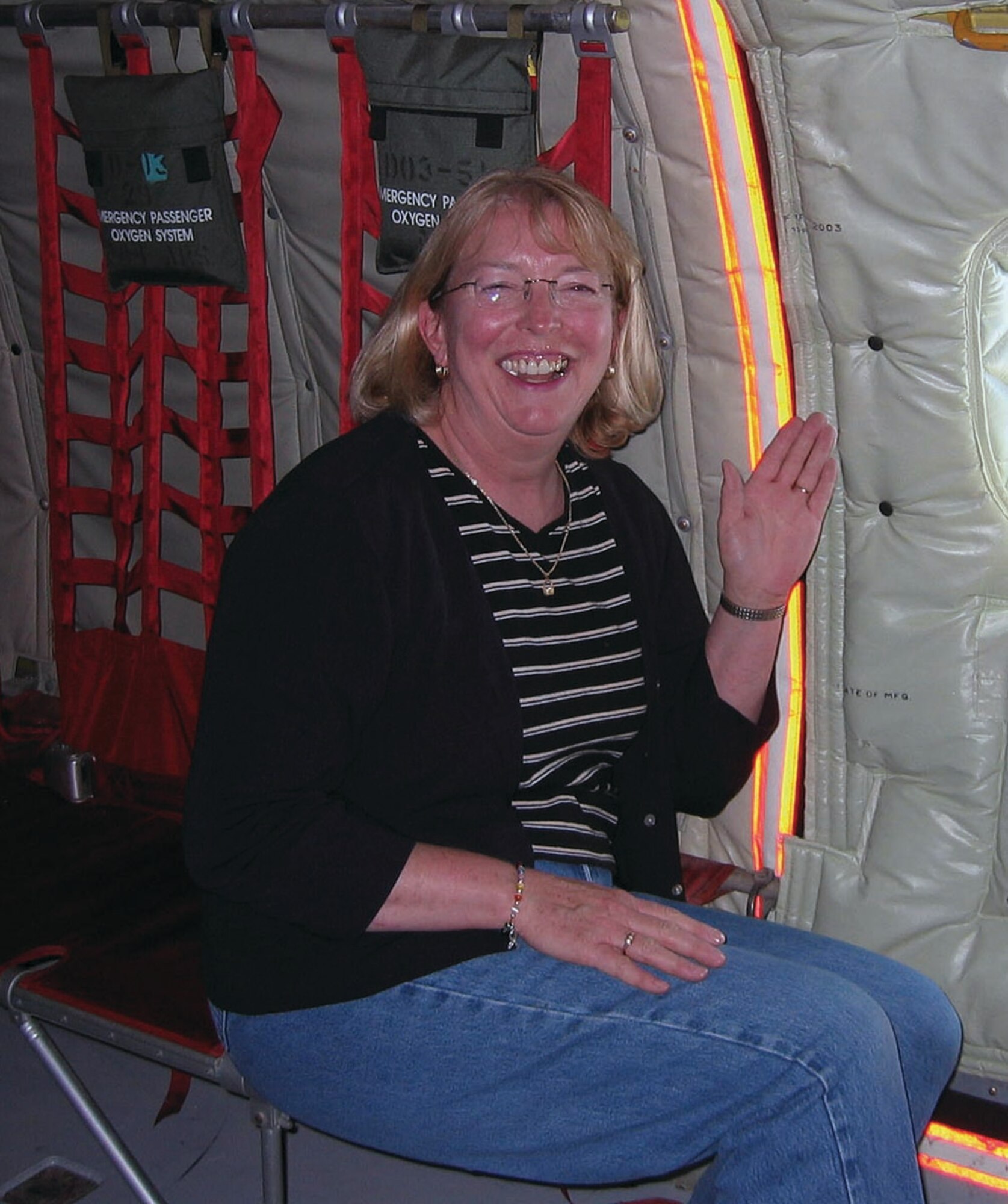 Mrs. Mary Borst, 931st Air Refueling Group Budget Officer waves as she waits for the opportunity to see air-to-air refueling during the incentive flight she participated in May 17. 