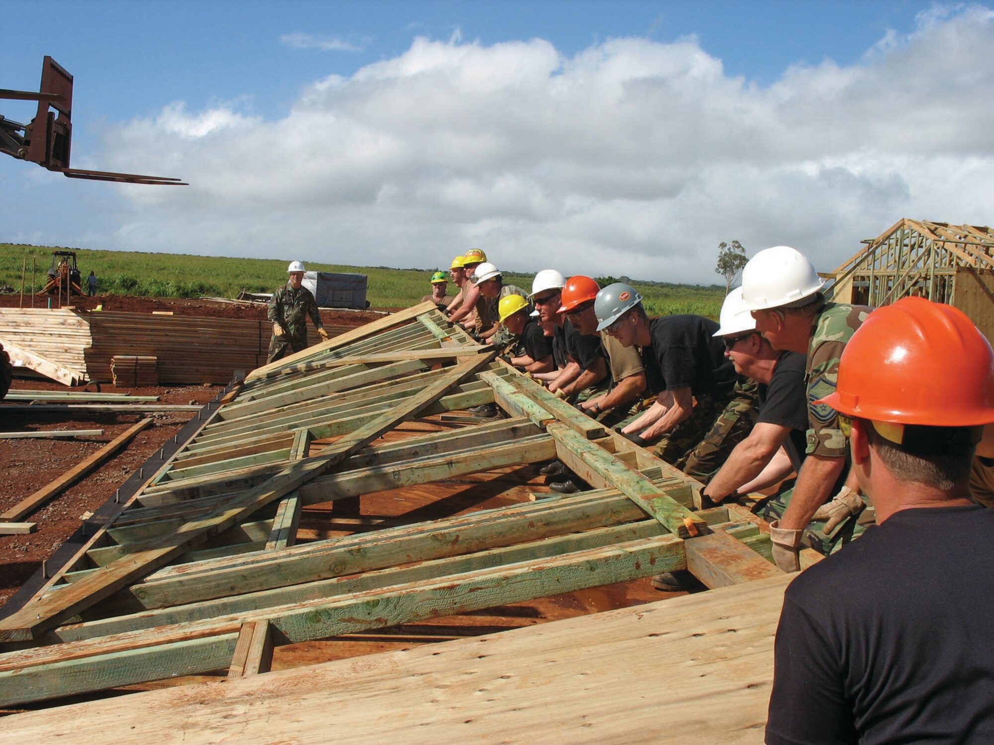 Members with the first rotation of the 931st CES team up to lift part of a frame into place. The 931st CES took part in the Innovative Readiness Project from April 29 to May 28.