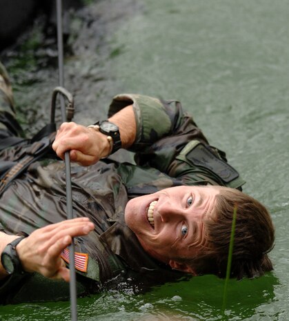 Tech. Sgt. Dana Vaughan pulls himself across a cold Vermont pond on Thursday, June 8, 2006. Sergeant Vaughan, a pararescueman from Nellis Air Force Base, Nev., is attending a two-week summer mountaineer training course at the Vermont National Guard's Army Mountain Warfare School in Jericho, Vt. (Air National Guard photo/Master Sgt. Rob Trubia) 