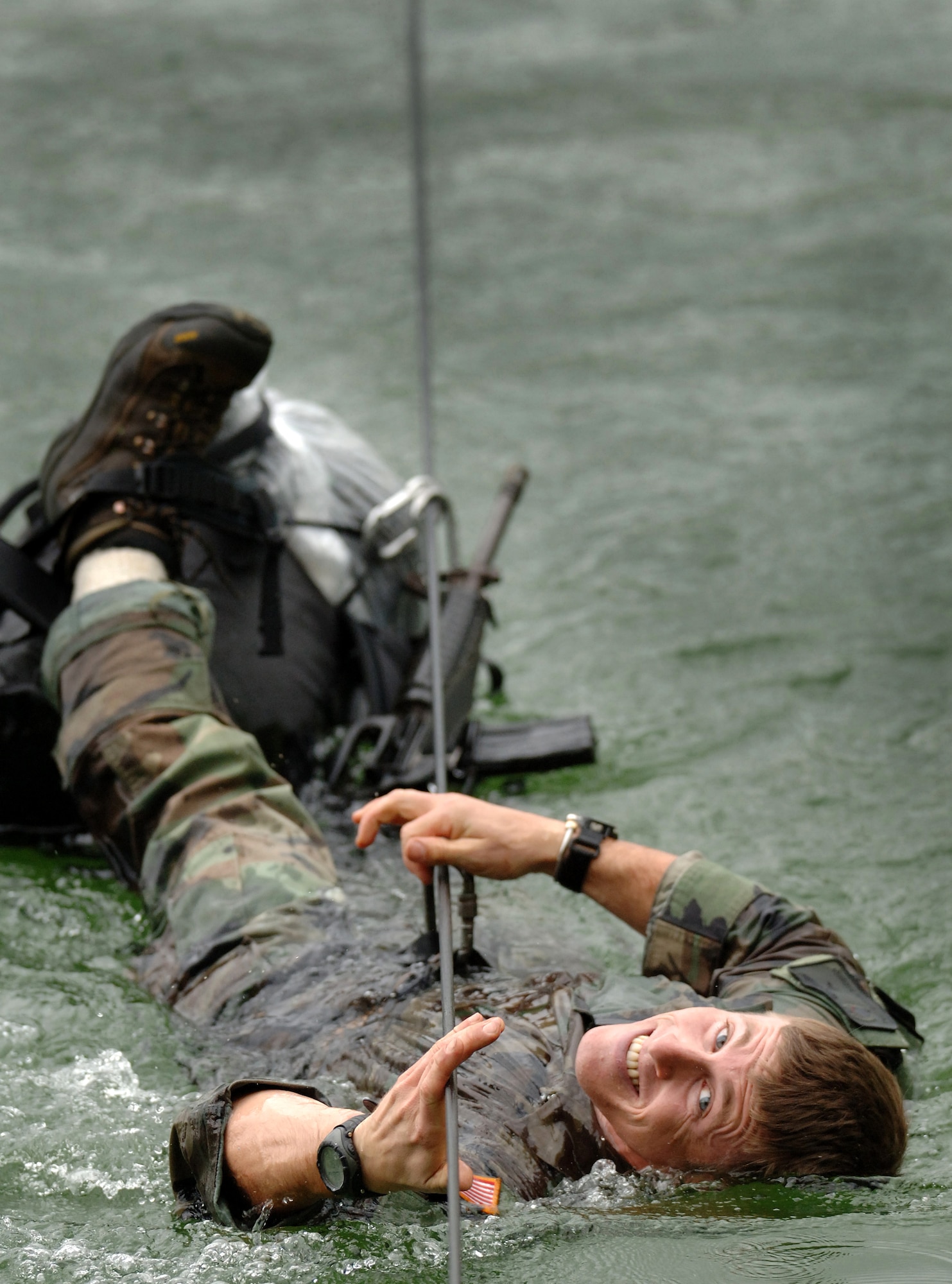 Tech. Sgt. Dana Vaughan pulls himself across a cold Vermont pond on Thursday, June 8, 2006. Sergeant Vaughan, a pararescueman from Nellis Air Force Base, Nev., is attending a two-week summer mountaineer training course at the Vermont National Guard's Army Mountain Warfare School in Jericho, Vt. (Air National Guard photo/Master Sgt. Rob Trubia) 