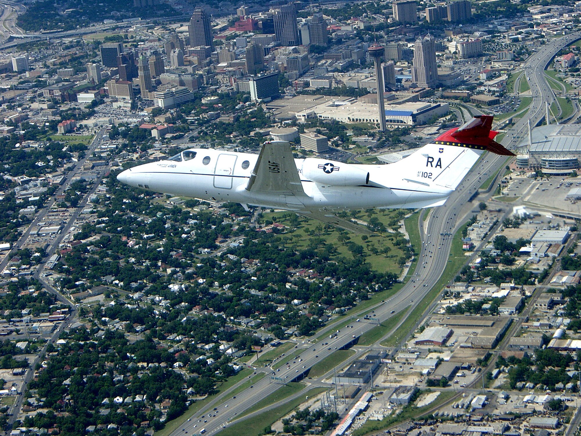 A T-1A Jayhawk flies over downtown San Antonio. The aircraft is assigned to the 99th Flying Training Squadron at Randolph Air Force Base, Texas. (U.S. Air Force photo/Lt. Col. Russell Hopkinson) 
