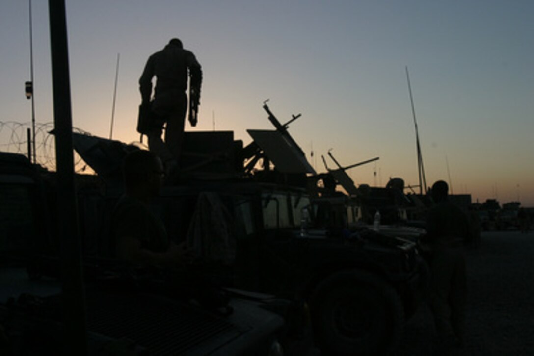 U.S. Marines from 2nd Platoon, Hotel Battery, 1st Battalion, 14th Marine Regiment conduct pre-convoy inspections on their humvees at Camp Fallujah, Iraq, on June 7, 2006. 