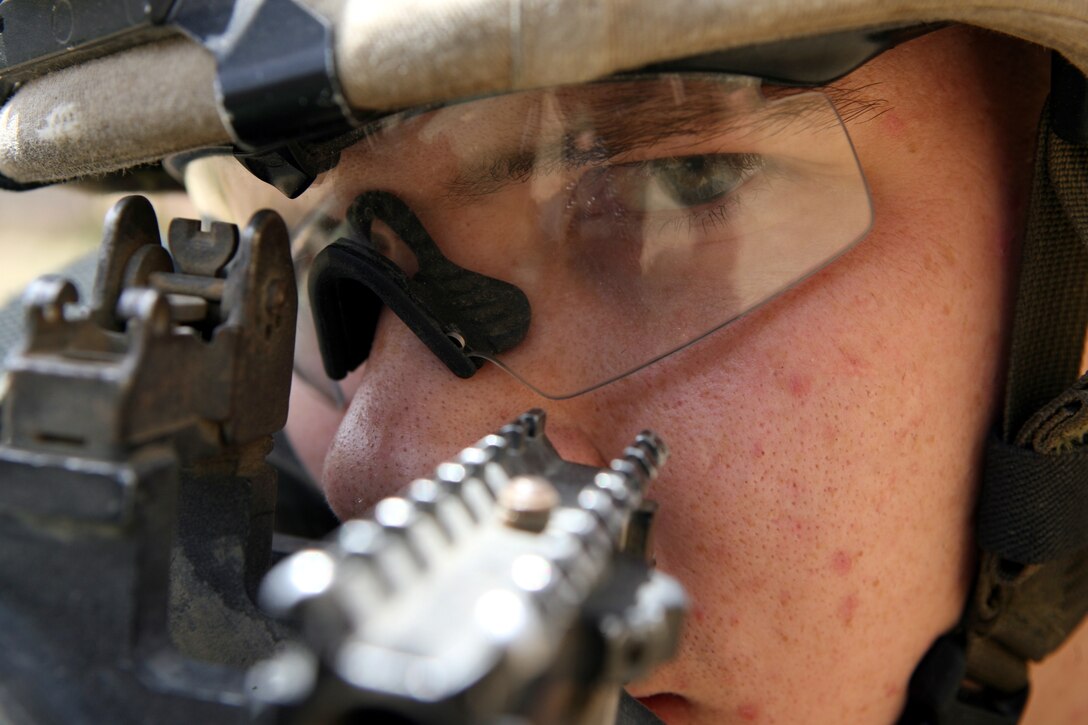 RAMADI, Iraq - Lance Cpl. Richard M. Mason II, an assaultman for 2nd Platoon, K Company, 3rd Battalion, 8th Marine Regiment, sights down range with his rocket launcher. Nicknamed the "Rocket Man," the 21-year-old from Medina, Ohio has effectively fired 24 rockets using the Shoulder-Launched Multi-Purpose Assault Weapon or SMAW during combat operations in Ramadi. The portable anti-armor rocket launcher has the sole purpose of destroying bunkers and other fortifications during assault operations.
