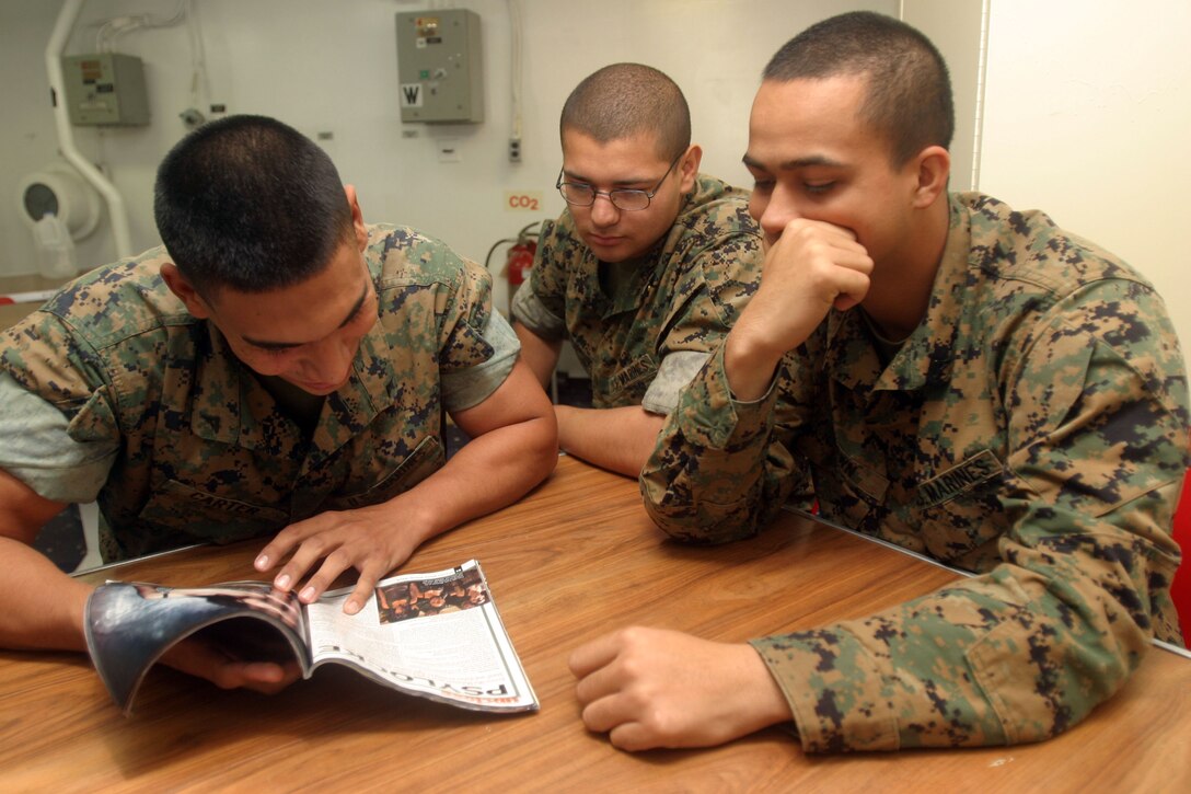 ABOARD THE USS BOXER,  (June 10, 2006) -- Three Marines with the 15th Marine Expeditionary Unit's Maritime Special Purpose Force Security Element kill some time by reading magazine while aboard the USS Boxer during the Units first at sea training exercise. The 15th MEU has two more at sea training exercises sheduled before a deployment to the Western Pacific later this year.