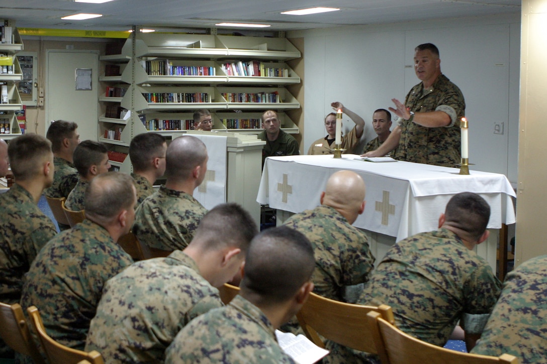 Navy Commander Gary W. Carr, 24th Marine Expeditionary Unit chaplain from Lansing, Mich., participates in religious services aboard the USS Iwo Jima June 11.  The 24th MEU last week began an expected six-month deployment to the European and Central Command theaters of operation.