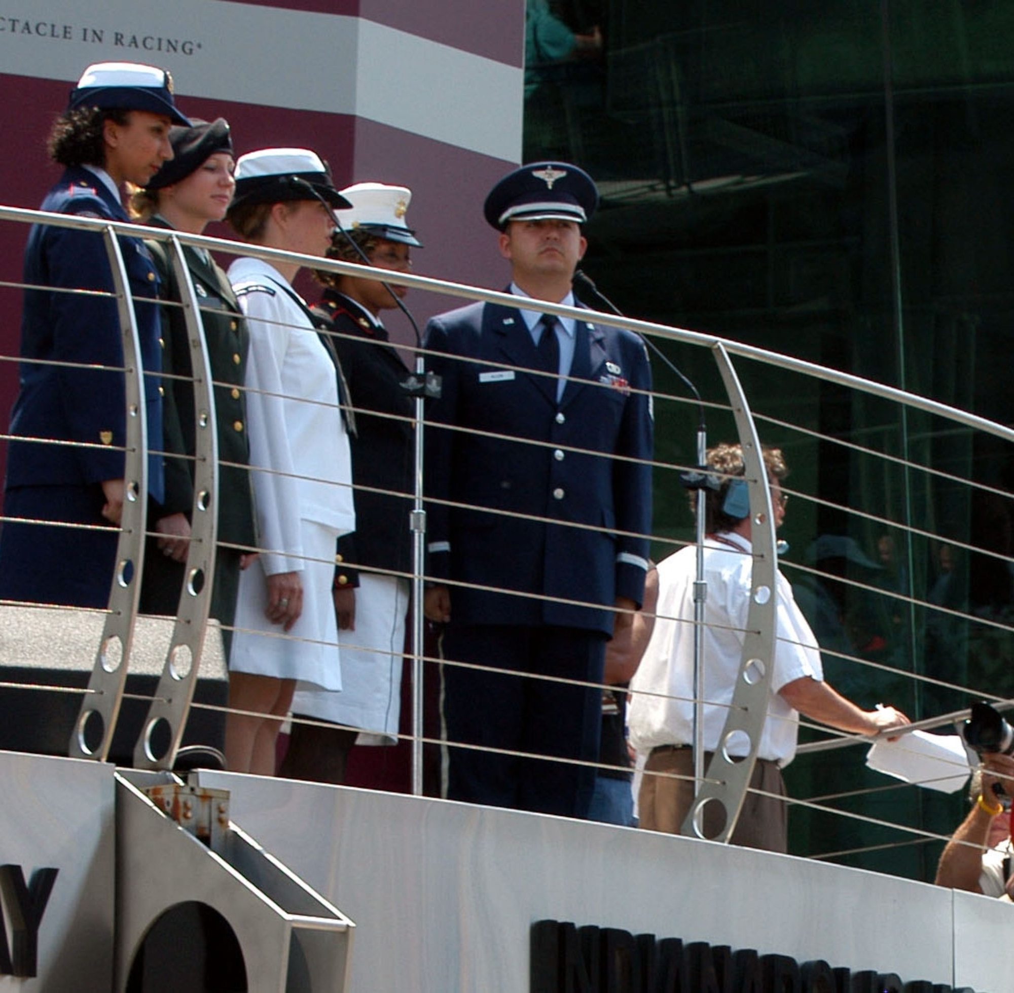 INDIANAPOLIS  — Staff Sgt. E. Justin Allen stands on the Victory Podium at Indianapolis Motor Speedway with Coast Guard Petty Officer 1st Class Lisa Taylor, Army Sgt. Jennifer Castle, Navy Petty Officer 3rd Class Landon Crissup and Marine Gunnery Sgt. Remayl L. Shaffer-Hardy. They were in Indianapolis to perform the National Anthem at the 90th running of the Indianapolis 500. (DoD photo by Samantha L. Quigley)

