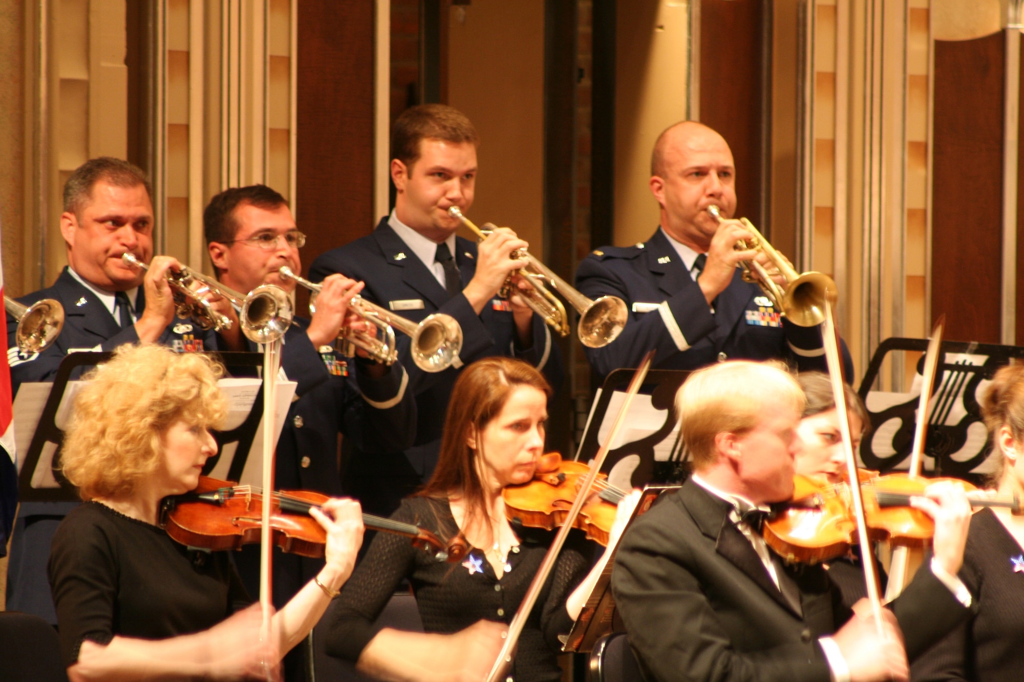 CLEVELAND— Staff Sgt. Eric Knorr, Airman 1st Class David Diamond, Senior Airman Jason Smith and 2nd Lt. David Alpar join the Cleveland Pops Orchestra onstage for the finale of Beethoven’s “Wellington’s Victory.”  Members of Band of Flight marched to the stage and musically represented the British and French forces during the Battle of Vitoria in Spain on June 21, 1813.  Britain’s Duke of Wellington ultimately won the day. (Air Force photo by 1st Lt. Ellen Harr)

