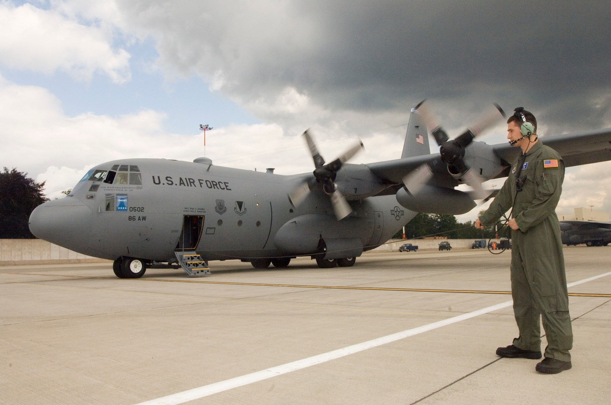 Airman 1st Class Michael Wilson waits for passengers to board a C-130 Hercules at Ramstein Air Base on Monday, June 5, 2006, for the day's mission to Stuttgart and Grafenwoehr, Germany. Airman Wilson is a loadmaster with the 37th Airlift Squadron at Ramstein. (U.S. Air Force photo/Master Sgt. John E. Lasky)
