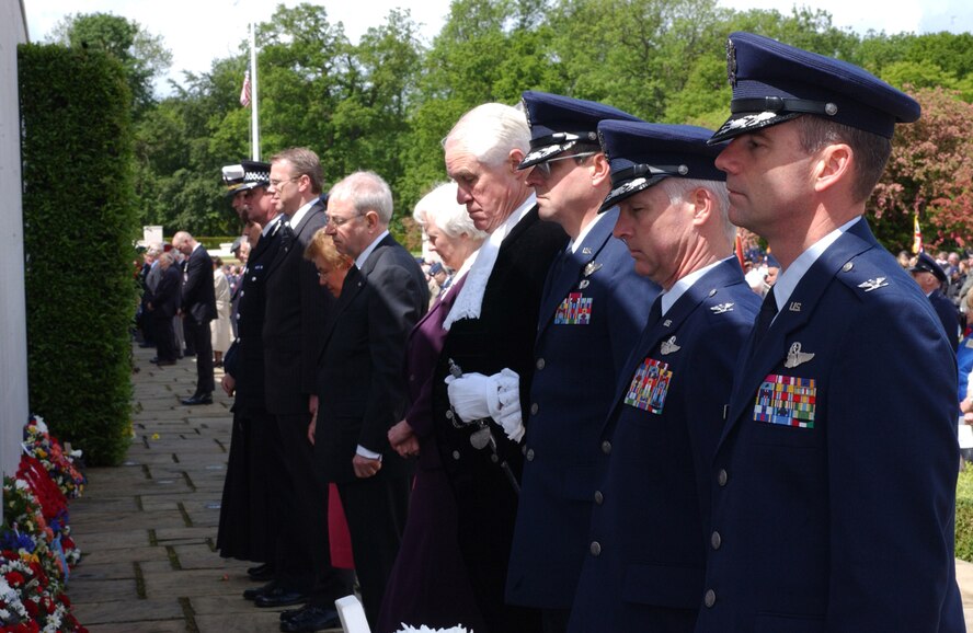 Col. Blake Lindner, third right, 501st Combat Support Wing commander, Col. Mike Callis, second right, 100th Air Refueling Wing vice commander, and Col. Jay Silveria, 48th Fighter Wing vice commander, right, stand with other honored guests from around U.S. Air Forces in Europe and England and bow their heads during a moment of silence at the Memorial Day ceremony May 29 at Madingley American Cemetery near Cambridge. Wreaths were laid to honor those fallen members who lost their lives during World War II.  (U.S. Air Force photo by Airman 1st Class Kristi L. Elmer)