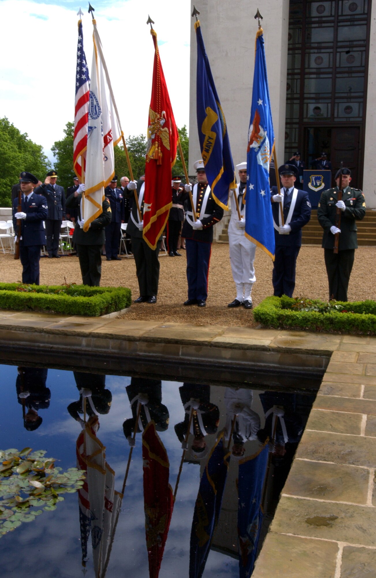 Servicemembers from RAF Mildenhall stand at parade rest May 28 during the Leiston Memorial Event. U.S. military members were among many who took part to help honor and remember the men of the 357th Fighter Group who had been stationed at Leiston and flew P-51 Mustangs during World War II. (U.S. Air Force photo by Airman 1st Class Kristi L. Elmer)