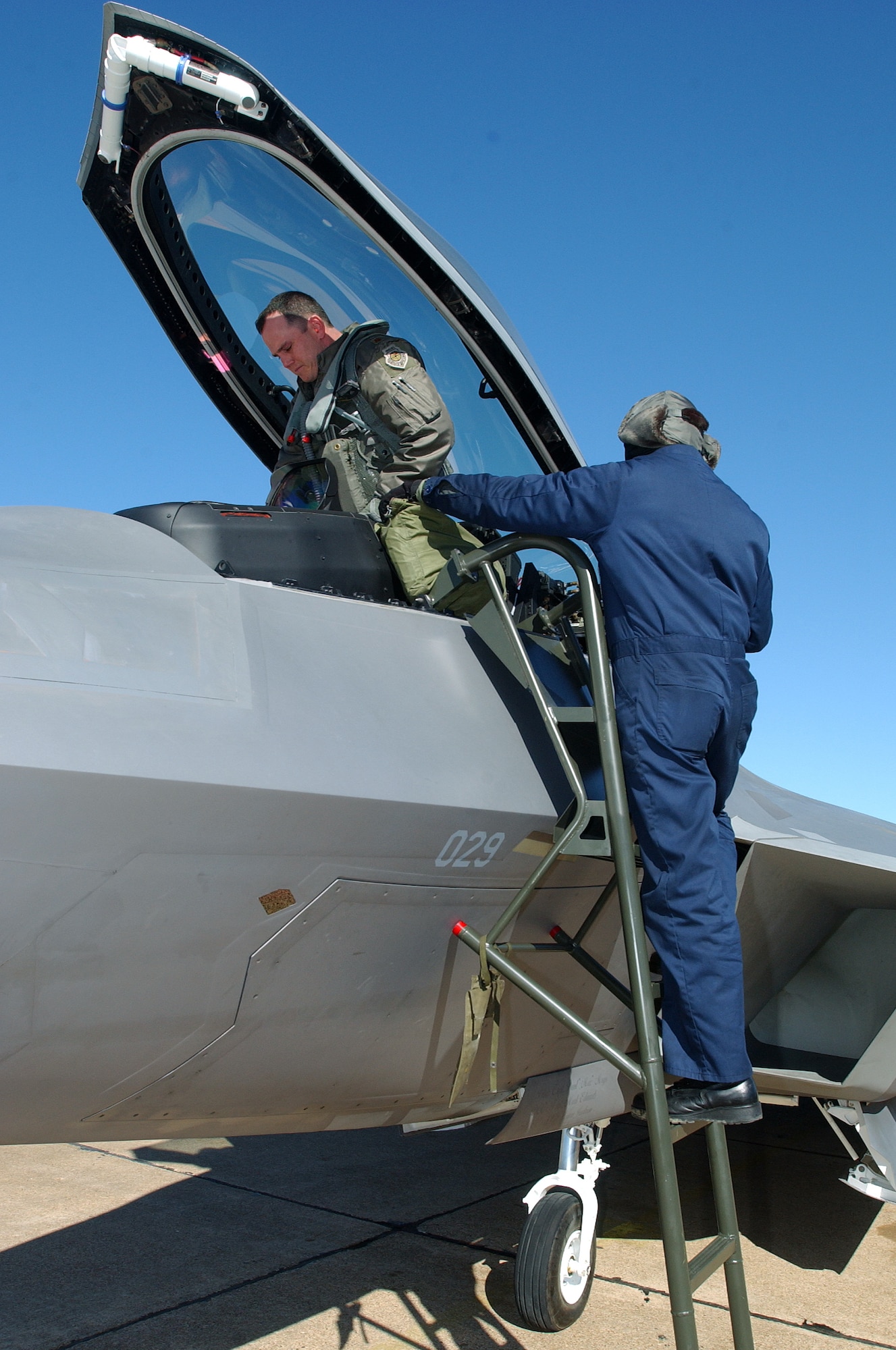 Major Charles "Corky" Corcoran, a 27th Fighter Squadron Fighter Pilot, prepares for his F-22A flight with the help of Staff Sgt. John Barr, a 27th AMU Crew Chief. The F-22A Raptor Stealth Fighter Jet made a historic flight from Langley Air Force Base, Virginia being its first generated sortie from Langley and piloted by a Langley based pilot. (US Air Force photo by Staff Sgt. V. Levi Collins)