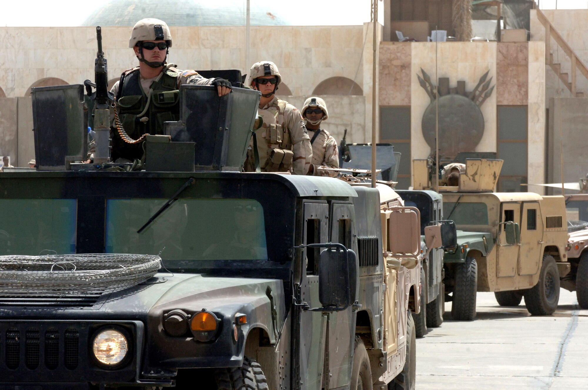Senior Airman Jonathon Ray sits atop the lead vehicle of a convoy of Air Force Humvees waiting to roll during a Army and Air Force joint operation in support of a presidential security mission in Baghdad on June 13, 2006.   Security forces, explosive ordnance disposal and medical Airmen participated in the exercise.  All were from the 447th Air Expeditionary Group.  Airman Ray is deployed from the Texas Air National Guard's 147th Fighter Wing at Ellington Field in Houston. (U.S. Air Force photo/Staff Sgt. Bryan Bouchard)