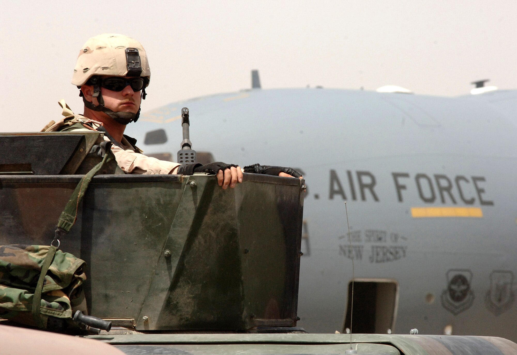 Senior Airman Jonathon Ray mans the turret atop a Humvee during a Army and Air Force joint operation in support of a presidential security mission in Baghdad on June 13, 2006.  Airman Ray is assigned to the 447th Air Expeditionary Group and is deployed from the Texas Air National Guard's 147th Fighter Wing at Ellington Field in Houston. (U.S. Air Force photo/Staff Sgt. Bryan Bouchard) 