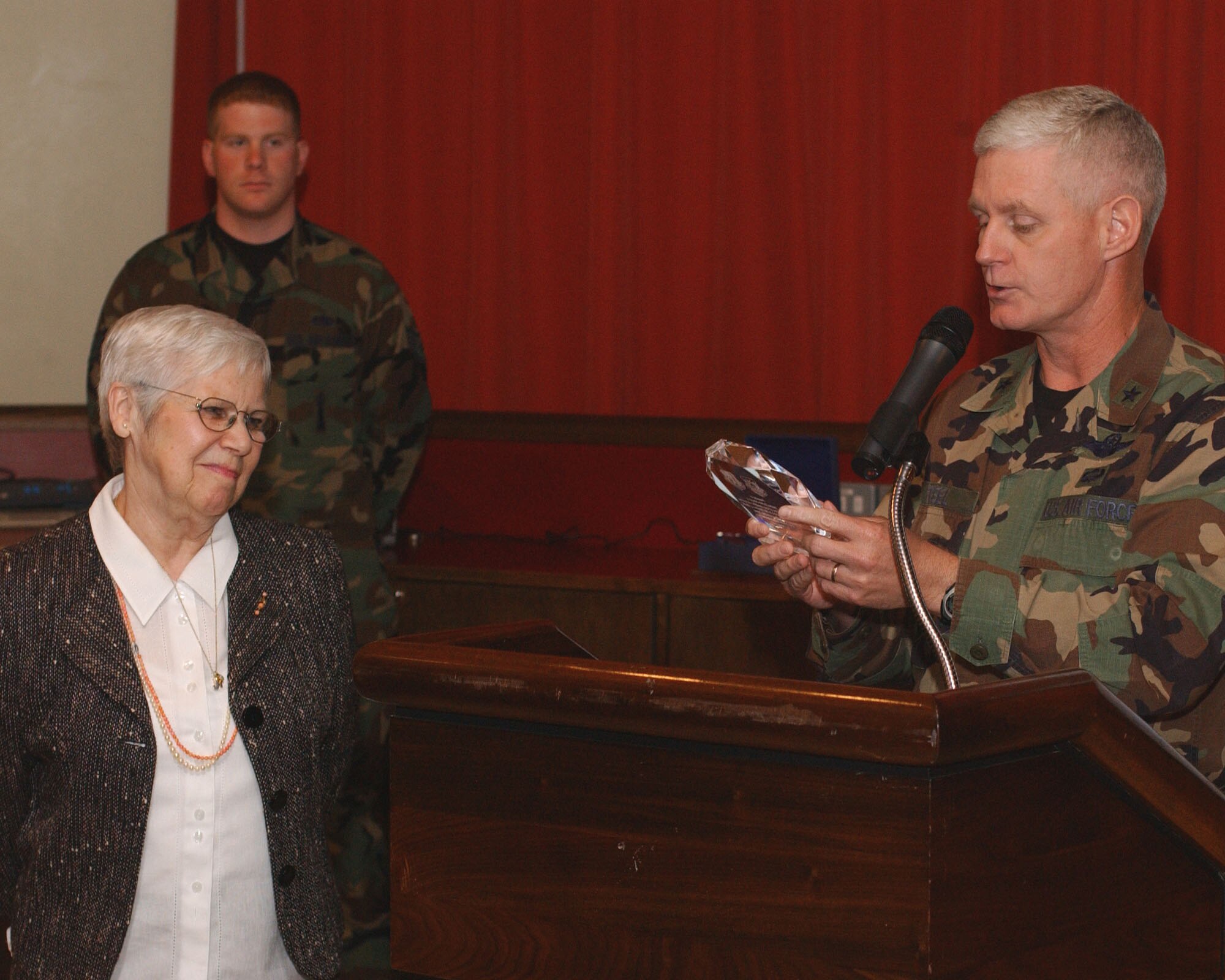 Brig. Gen. Robert Steele, right, 48th Fighter Wing commander, presents Janina Fischler-Martinho, left, a survivor of the Holocaust, with an appreciation award at this year’s Holocaust remembrance luncheon at RAF Mildenhall May 3. (U.S. Air Force photo by Senior Airman Cecil McCloud)