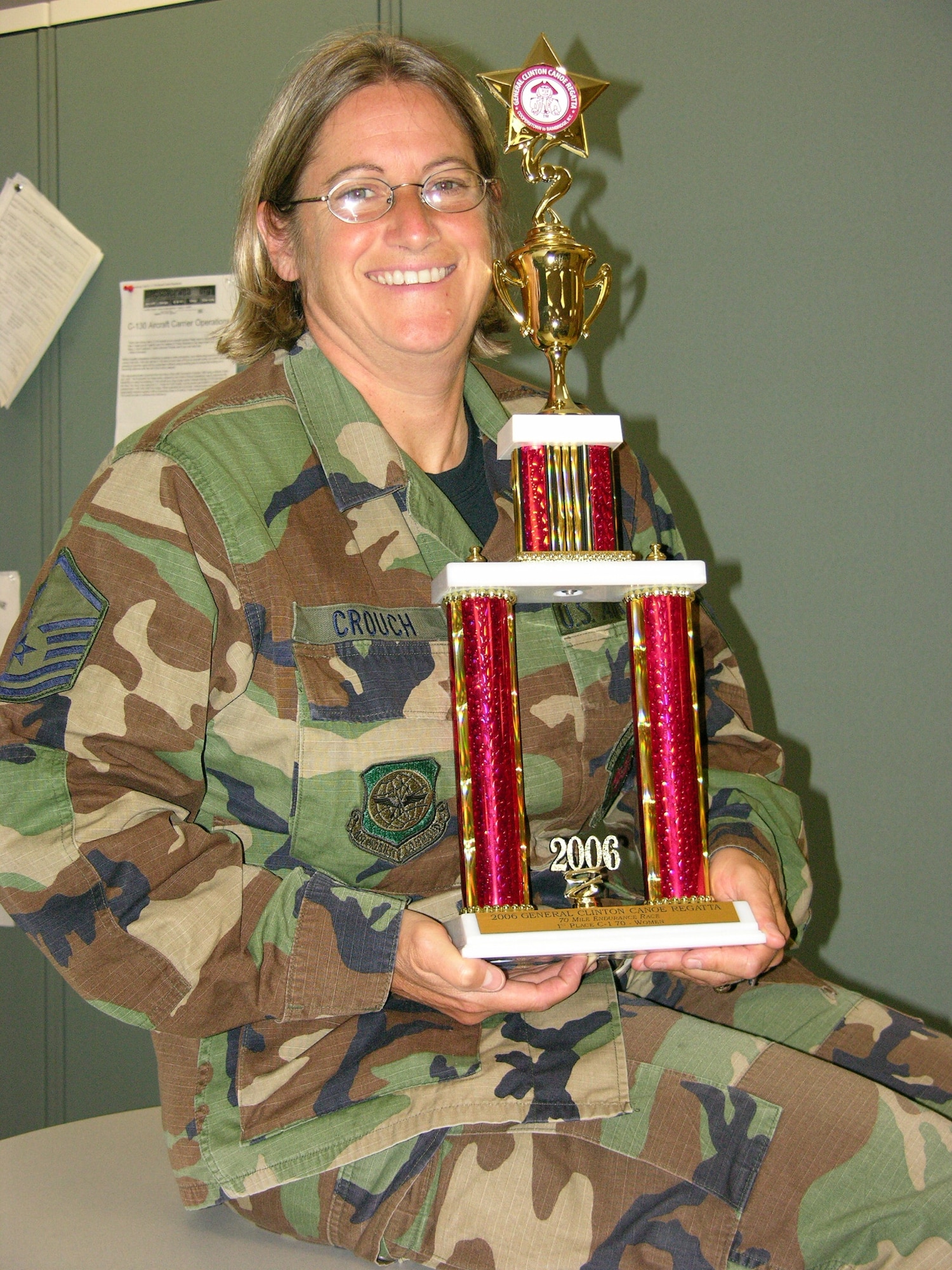 Master Sgt. Helen Crouch holds a trophy she won from a recent canoe regatta she paddled in New York state. (Courtesy photo)