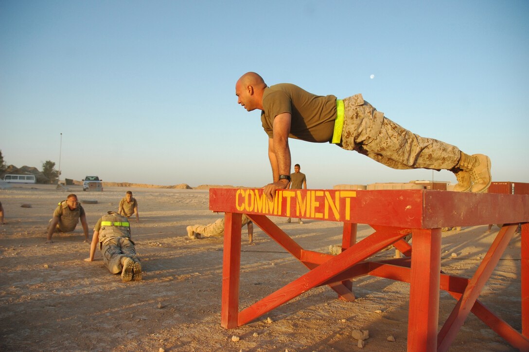 AL ASAD, Iraq - Staff Sgt. William G. Cuellar leads the Marines enrolled in Corporal's Course in physical training on the flight line at June 14. The course teaches newly noncommissioned officers the skills needed to lead junior Marines, both in battle and in their respective military occupational specialties. Cuellar, a generator mechanic with Combat Logistics Group 7, 1st Marine Logistics Group, and a native of Houston, is a chief instructor for the Corporal's Course held by Marine All-Weather Fighter Attack Squadron 533, Marine Aircraft Group 16 (Reinforced), 3rd Marine Aircraft Wing.