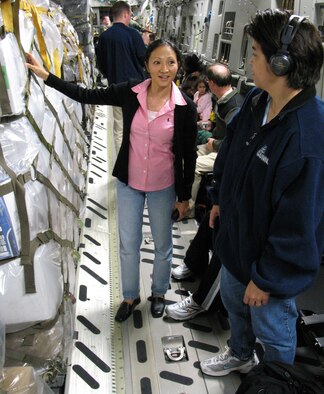 Lt. Col. Mylene Huynh and Capt. Kari Stone inspect their gear loaded on a C-17 Globemaster III while preparing to depart on a mission to Suva, Fiji from Hickam Air Force Base, Hawaii on June 14, 2006.  Lt. Col. Huynh and Capt. Stone work for Pacific Air Forces International Health Affairs. PACAF medical experts will train military members and participate in a health care outreach program in Fiji. (U.S. Air Force photo by Tech. Sgt. Chris Vadnais.)
