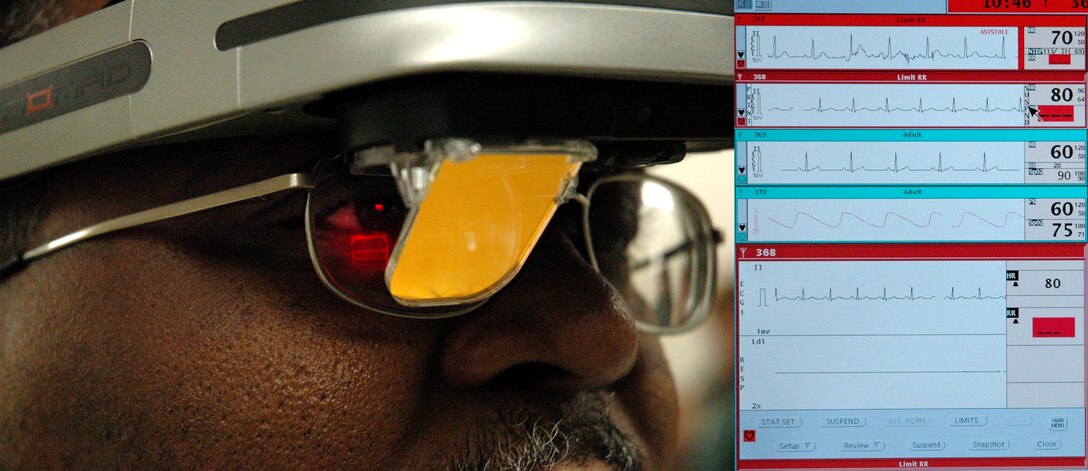 Col. (Dr.) James Henderson, director of the Air Force Expeditionary Medical Skills Institute, views a patient's vital signs (enlarged at right) through a medical heads-up display. Colonel Henderson is a member of the critical care air transport team executive council. (U.S. Air Force photo illustration/John Marshall)
