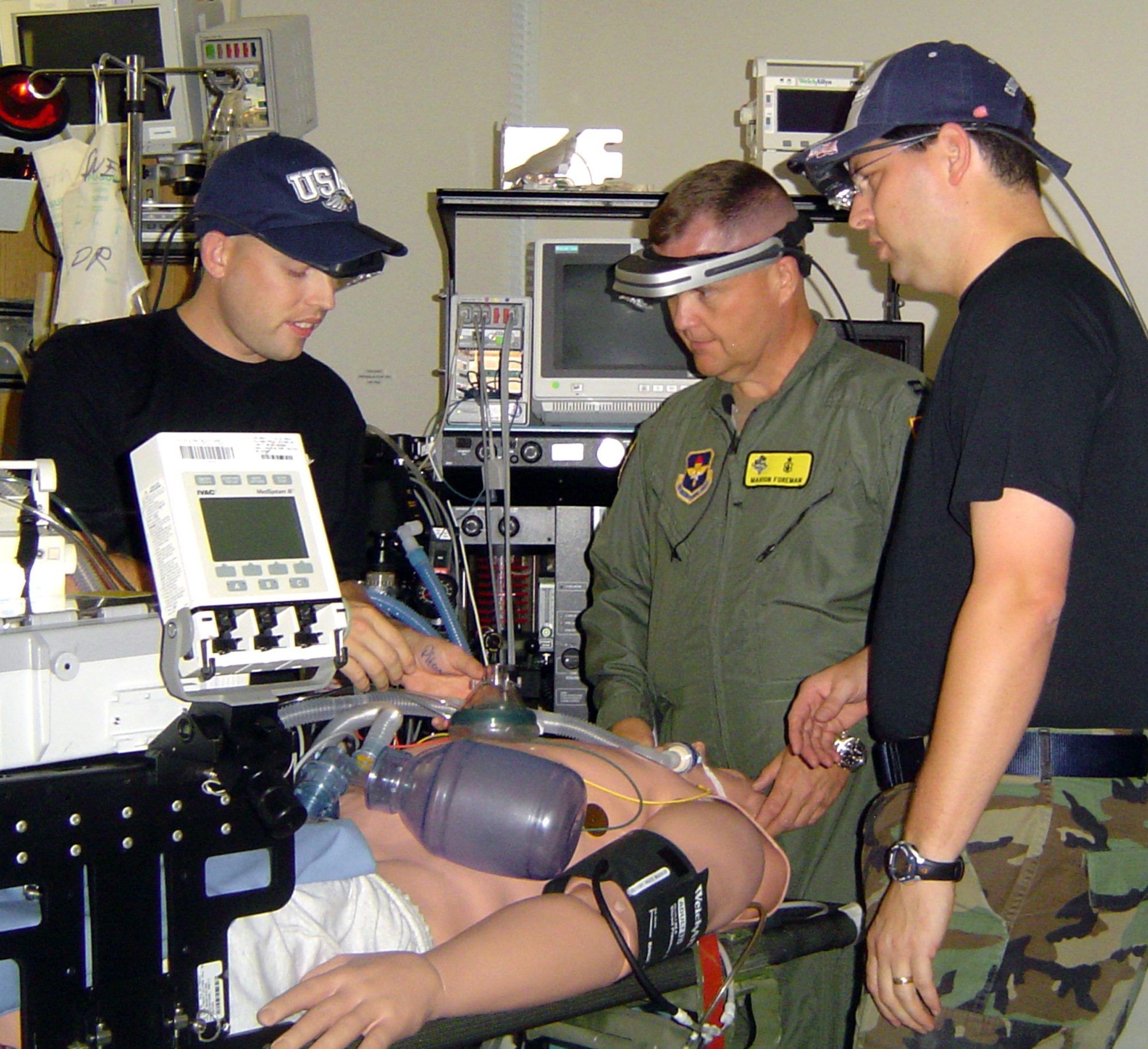 (From left) Staff Sgt. Matthew Falat, Capt. Marion Foreman and Maj. (Dr.) Mike Meyer test medical heads-up displays, or MHUDs, in the Wilford Hall Medical Center simulation center at Lackland Air Force Base, Texas. The MHUDs were developed by staff at the Air Warfare Battlelab at Mountain Home Air Force Base, Idaho. The hats were props used during the evaluation phase. (U.S. Air Force photo/Capt. Shaun Westphal)