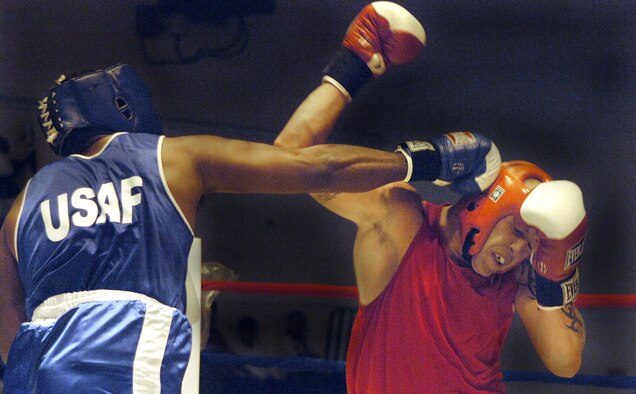 Army Sgt. Arien Edwards, a member of the Lackland Air Force Base boxing team,  connects with a straight right to the head of Royal Air Force Senior Aircraftsman Craig Donald in the first round of the Boxing Royale at the Bennett Fitness Center in San Antonio on Saturday, June 10. The event featured RAF boxers competing against U.S. military and local boxers. Donald won by decision. (U.S. Air Force photo/Tech. Sgt. Larry A. Simmons)
