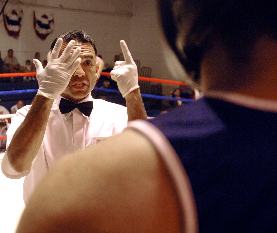 The referee gives a standing eight-count to Steven Moreno in the second round of his match against Royal Air Force Senior Aircraftsman Richard Lewis at the Boxing Royale at the Bennett Fitness Center in San Antonio on Saturday, June 10. The event featured RAF boxers competing against U.S. military and local boxers. Lewis won the bout 42 seconds into the second round by referee's decision. (U.S. Air Force photo/Tech. Sgt. Larry A. Simmons)