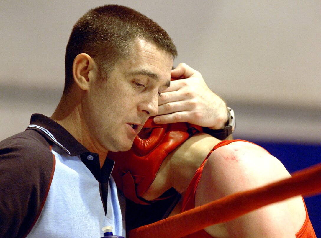 Royal Air Force Boxing Coach Cpl. Owen Spensley consoles RAF Senior Aircraftsman Chris Smyth after his loss to Gino Escamilla at the Boxing Royale at the Bennett Fitness Center in San Antonio on Saturday, June 10. The event featured RAF boxers competing against U.S. military and local boxers. (U.S. Air Force photo/Tech. Sgt. Larry A. Simmons)