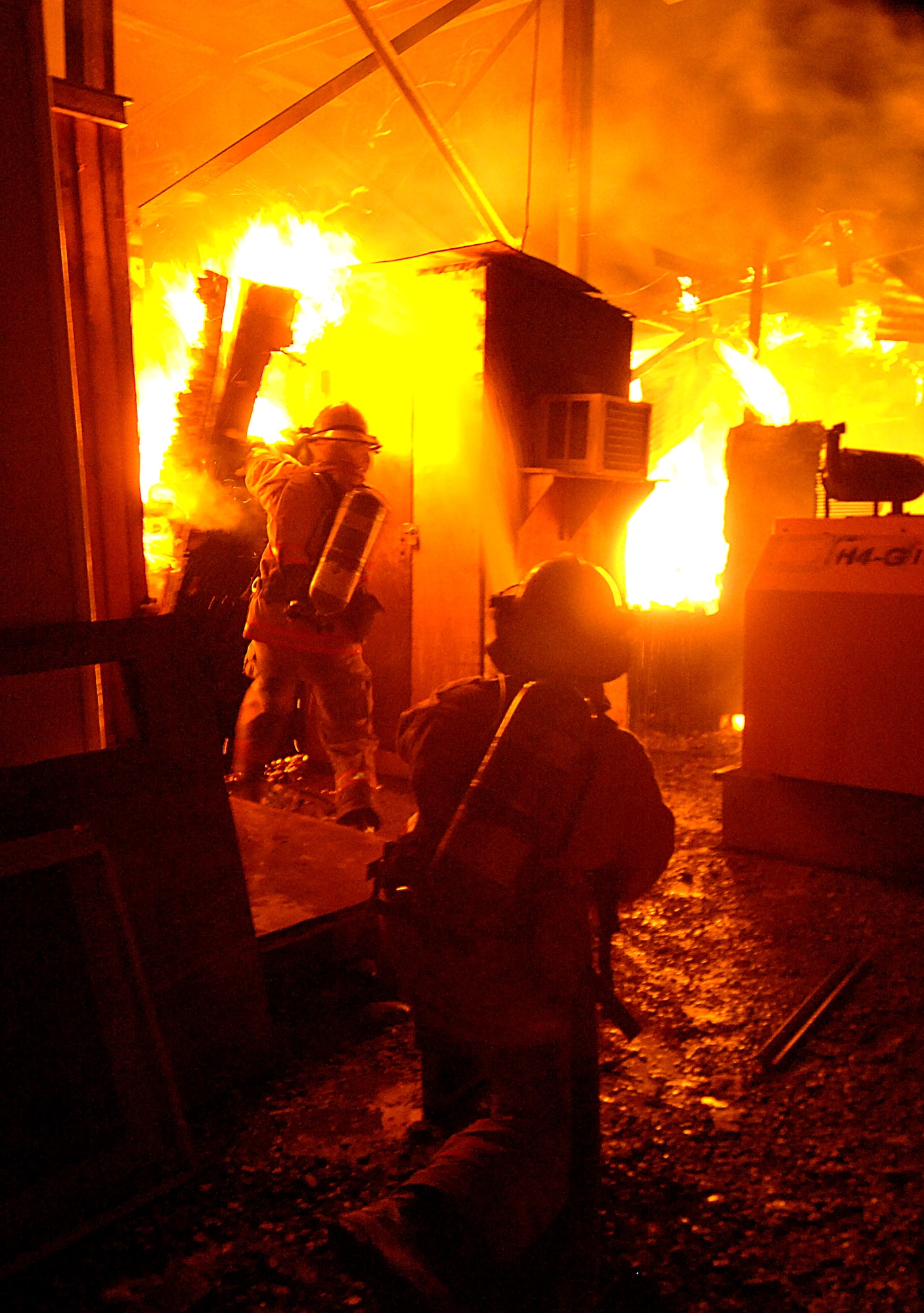 Firefighters from contractor Wackenhut Fire and Emergency Service battle a fire at Forward Operating Base Marez in Mosul, Iraq, on Thursday, June 8. The fire was at a local restaurant and jewelry store. (U.S. Air Force photo/Tech. Sgt. Jeremy T. Lock) 




