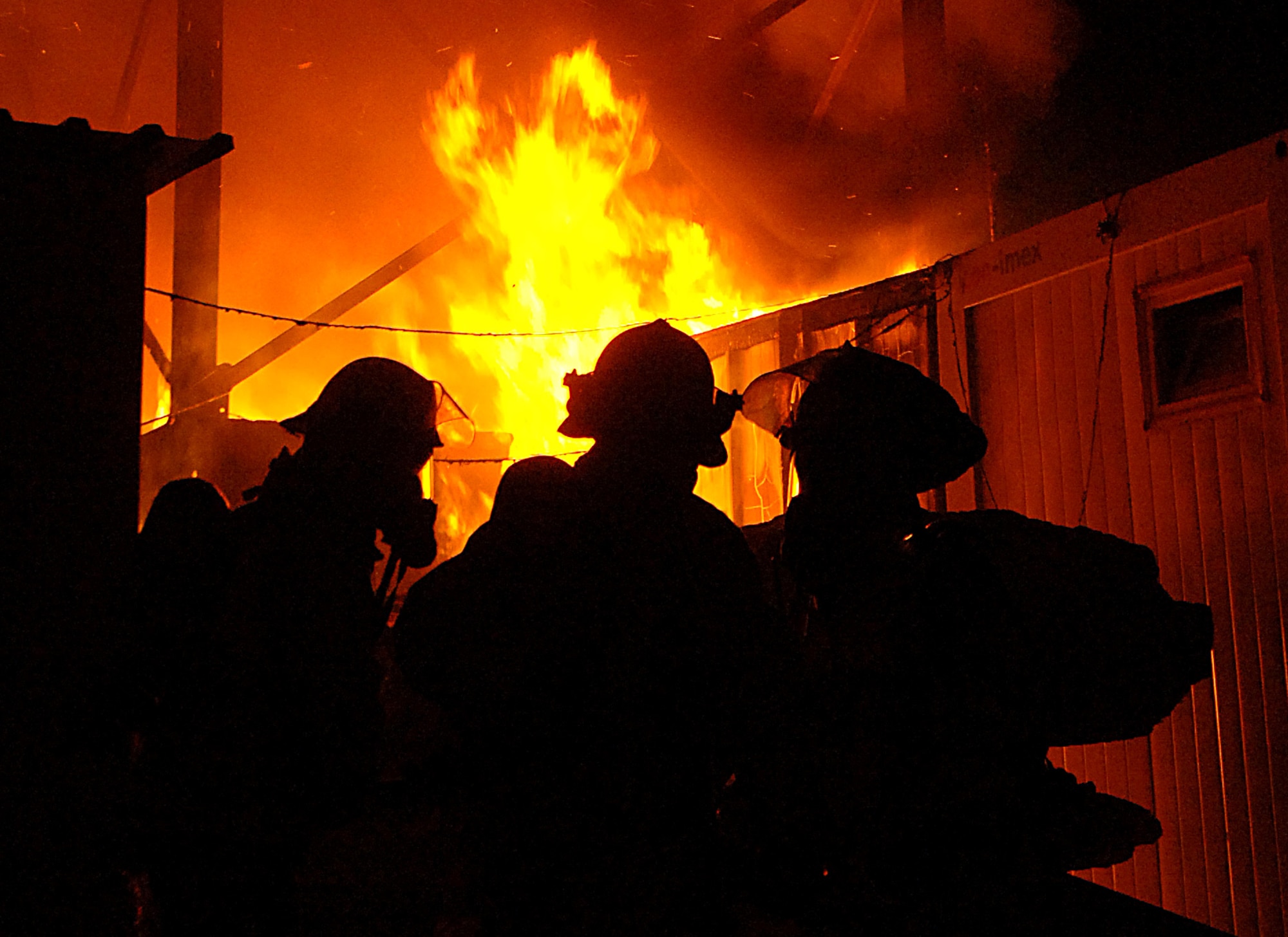 Firefighters from contractor Wackenhut Fire and Emergency Service battle a fire at Forward Operating Base Marez in Mosul, Iraq, on Thursday, June 8. The fire was at a local restaurant and jewelry store. (U.S. Air Force photo/Tech. Sgt. Jeremy T. Lock)
