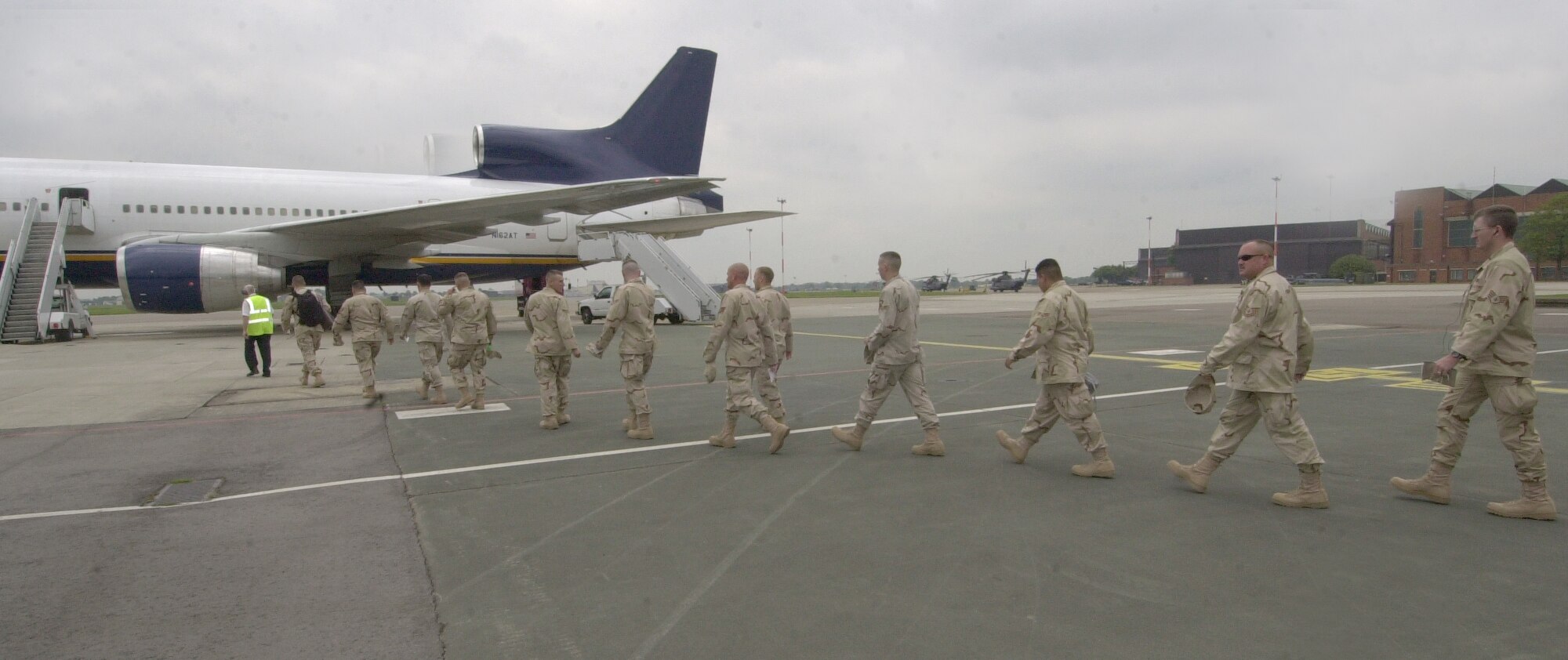 Members of the 48th Security Forces Squadron, RAF Lakenheath, and reserve personnel from the 71st Security Forces Squadron, Vance Air Force Base, Okla., 910th Security Forces Squadron, Youngstown, Ohio, and the 934th Security Forces Squadron, Minneapolis, Minn. walk from the 727th Air Mobility Squadron passenger terminal to the aircraft waiting to take them to their deployed locations June 2.  (U.S. Air Force photo by Karen Abeyasekere)