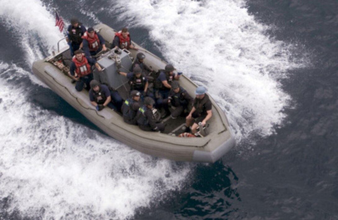 A visit, board, search and seizure team comprised of U.S. and Republic of Singapore sailors makes its way to the USS Tortuga for a boarding exercise while under way in the South China Sea on June 6, 2006. The sailors from the USS Crommelin (FFG 37) and the RSS Sea Lion (P 77) are training as a team as part of Cooperation Afloat Readiness and Training. The training is an annual series of bilateral maritime training exercises between the United States and six Southeast Asian nations. 