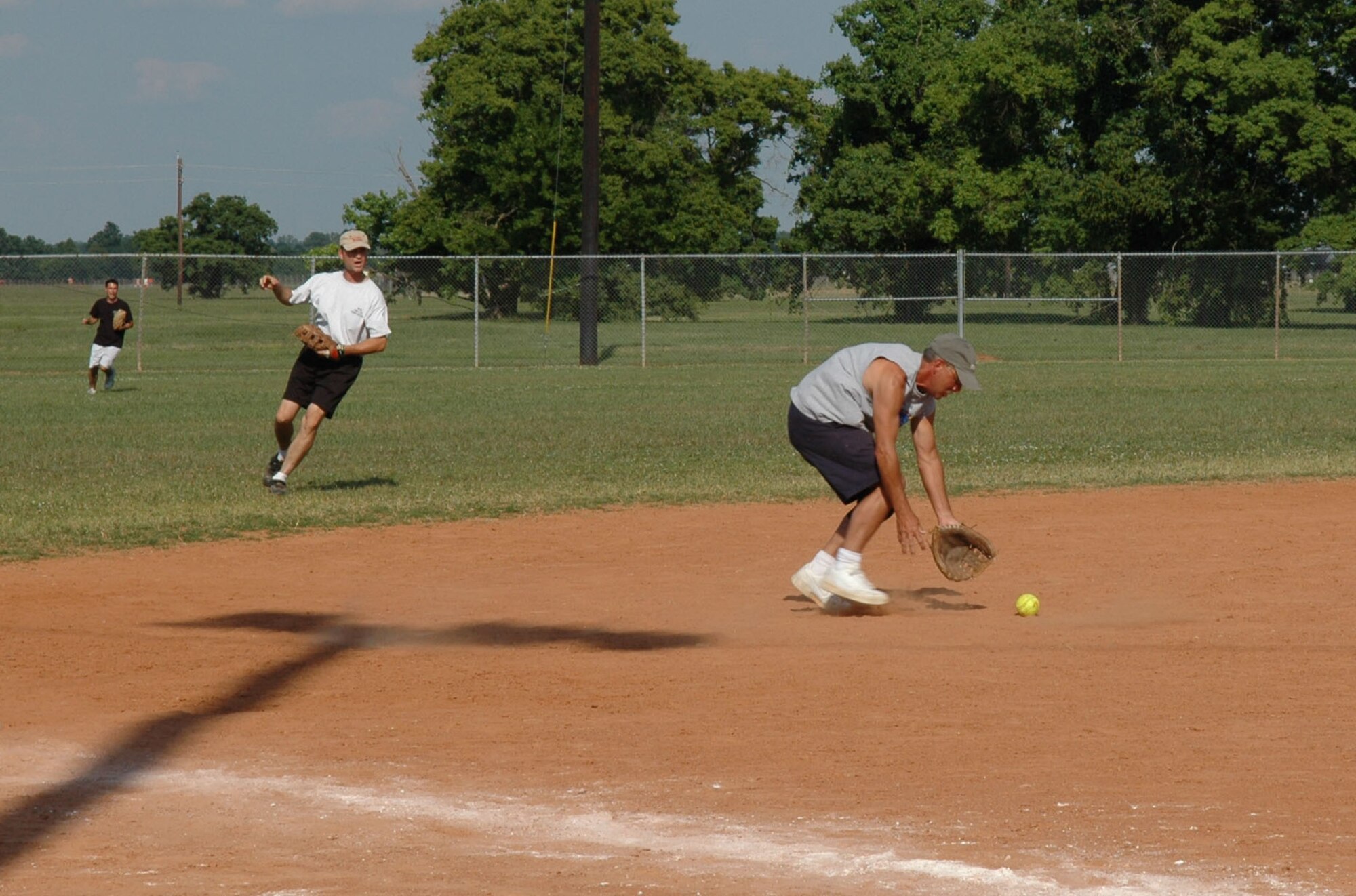 Bob Murray, 717th Aircraft Maintenance Squadron, goes for a grounder hit by the 917th Aircraft Maintenance Squadron (Photo by Senior Master Sgt. Jessica D'Aurizio). 